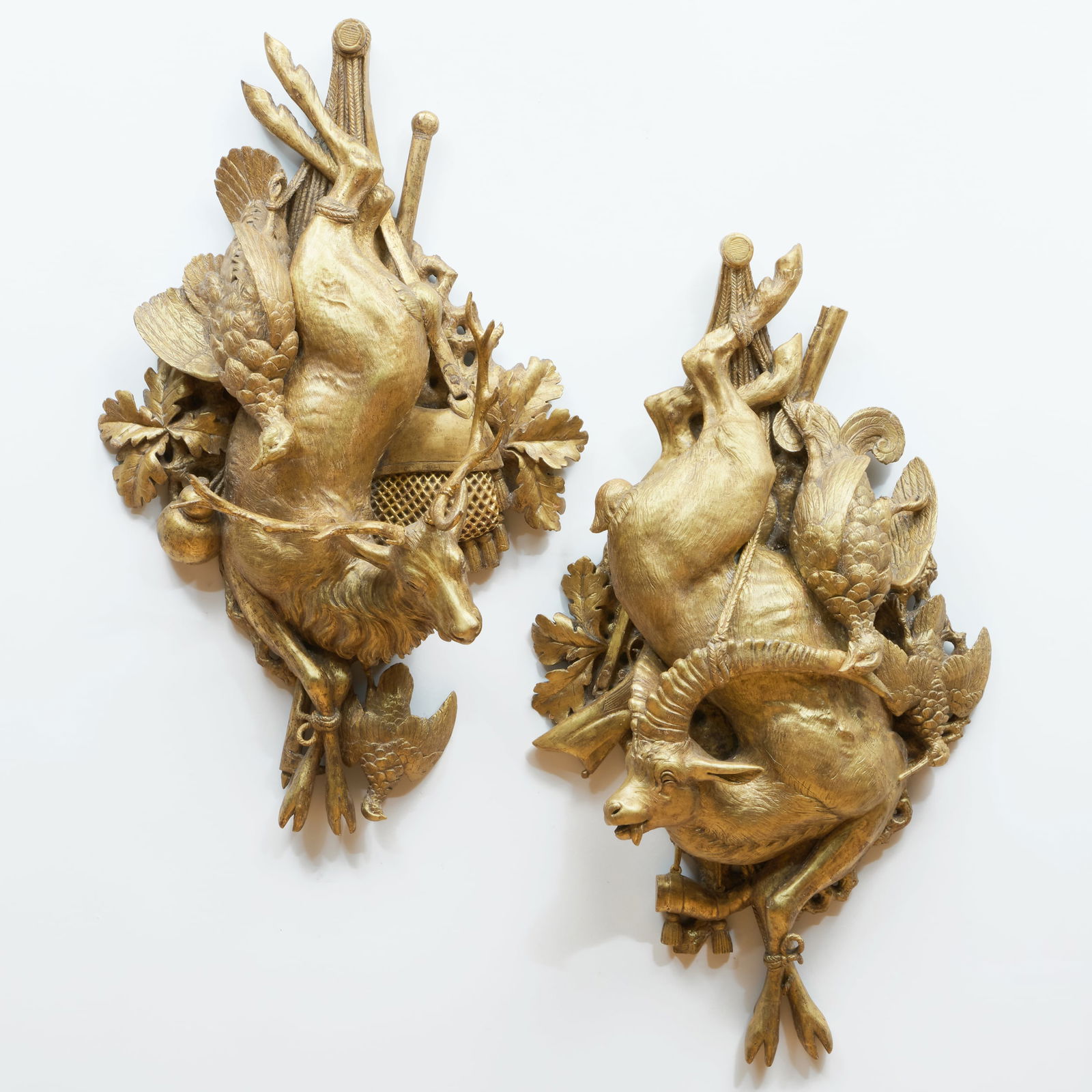 Pair of Louis XV Giltwood Hunting Trophies: Pair of Louis XV Giltwood Hunting Trophies Together with another later pair in plaster, modern, by Sotheby's Restoration. 37 x 22 x 7 1/4 in. The period pair acquired from Serge Roche and Jaques Rotil