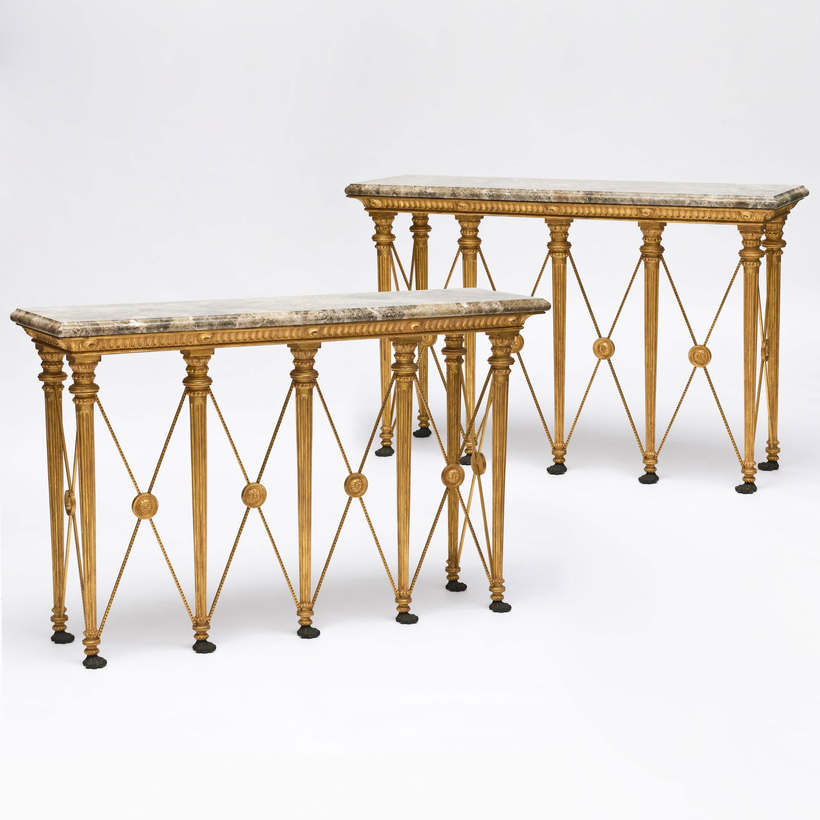 Pair of Italian Neoclassical Style Bronze-Mounted Giltwood and Gilt-Metal Console Tables, Modern: Pair of Italian Neoclassical Style Bronze-Mounted Giltwood and Gilt-Metal Console Tables, Modern Fitted with marble tops. 39 1/2 x 5 ft. 3 in. x 17 1/2 in. Supplied by Sotheby's Restoration, 1990s. Th