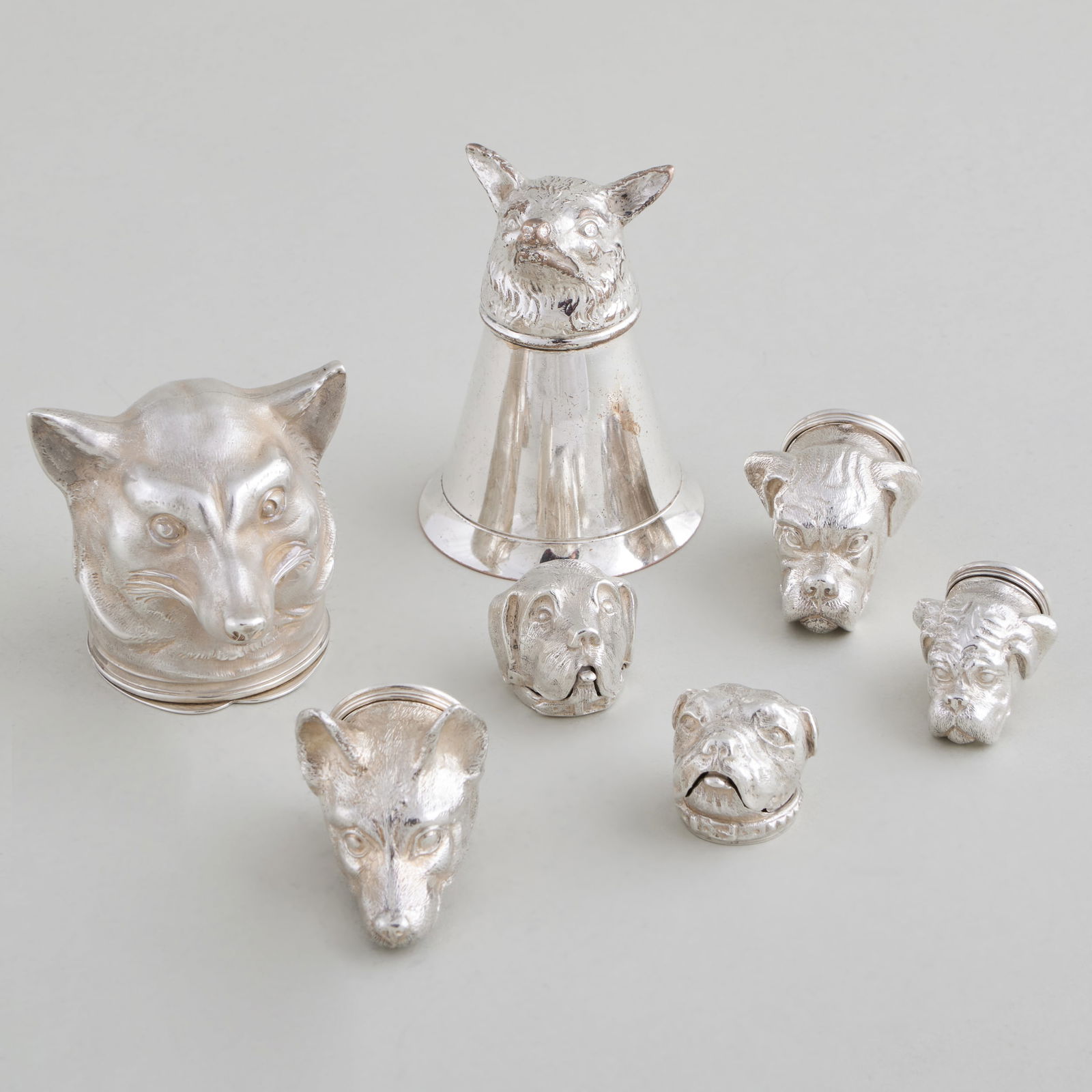 Group of Tiffany & Co. Silver Dog Form Pill Boxes, a German Fox Head Snuff Box and a Silver Plate: Group of Tiffany & Co. Silver Dog Form Pill Boxes, a German Fox Head Snuff Box and a Silver Plate Stirrup Cup Comprising: Three Tiffany & Co. pill boxes, marked London, 1972 Two Tiffany & Co. pill box