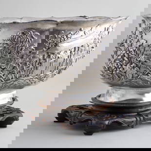 Japanese Silver Centerpiece Bowl: Japanese Silver Centerpiece BowlWith detached foot, character mark; together with a Chinese hardwood stand.The bowl and foot 11 3/4 x 19 3/4 in. diam., 312 oz. approx. gross weight.Sold Butterfield &