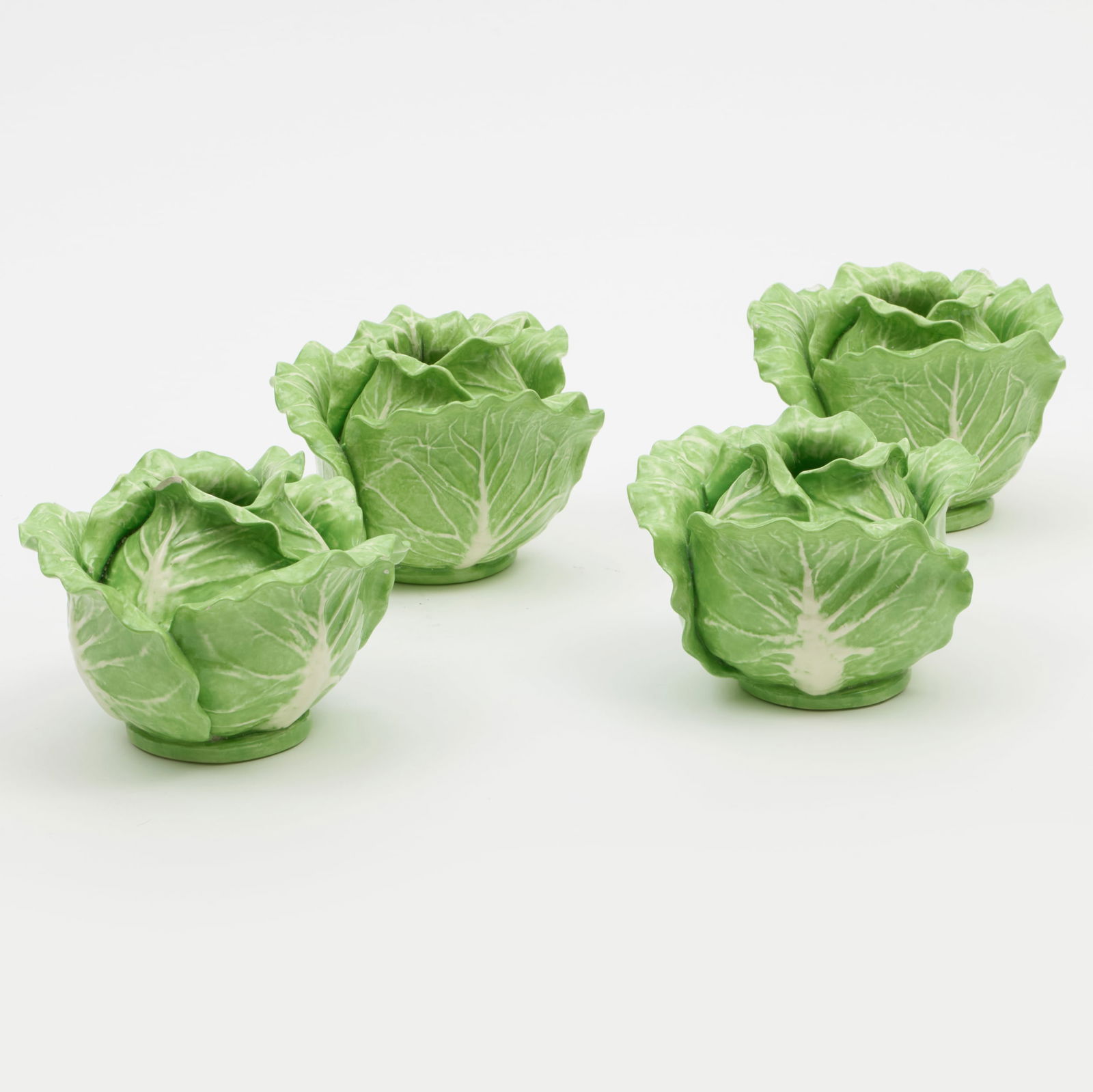 Group of Four Dodie Thayer Porcelain Cabbage Form Candle Holders: Group of Four Dodie Thayer Porcelain Cabbage Form Candle Holders Incised mark. 3 3/4 x 5 in. diam. The Collection of Carole Harris.