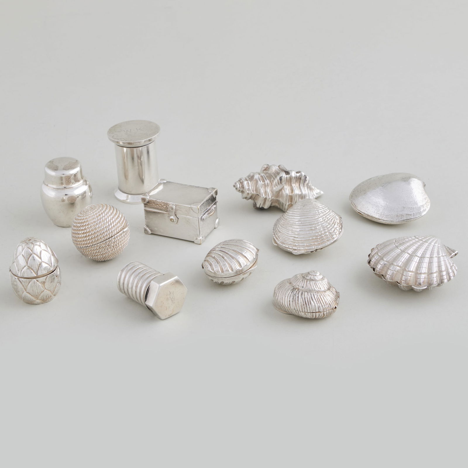 Group of Seven Tiffany & Co. Silver Trompe L'oeil Pill Boxes: Group of Seven Tiffany & Co. Silver Trompe L'oeil Pill Boxes Comprising: A clam shell box, marked 'Sterling' A scallop shell box, marked '.925' A conch shell box, marked 'Sterling' and '.925' A spool