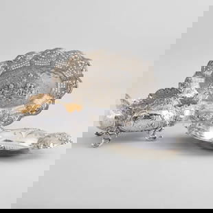 Two German Silver Dishes and a Reed & Barton Silver Dish: Two German Silver Dishes and a Reed & Barton Silver Dish Comprising: A dish on four feet, marked '.800' A pierced dish with putti, marked '.800' A dish with flower repousse, marked 'Sterling' The larg