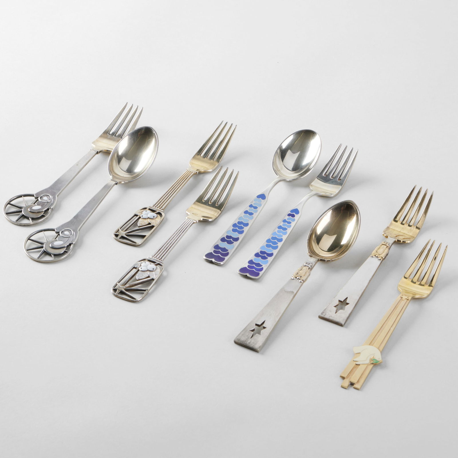 Set of Nine Jensen Silver and Enamel Commemorative Holiday Forks and Spoons: Set of Nine Jensen Silver and Enamel Commemorative Holiday Forks and Spoons Comprising: 1938 'Snowberry', pair of forks, designed by Ebbe Sadolin, mark of A. Michelsen and 'Sterling' 1940 'Star of Bet