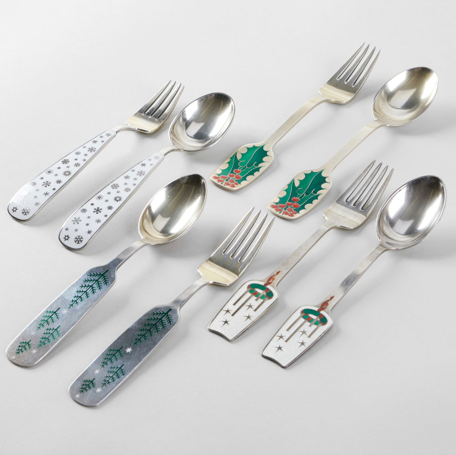 Set of Eight Jensen Silver and Enamel Commemorative Holiday Forks and Spoons: Set of Eight Jensen Silver and Enamel Commemorative Holiday Forks and Spoons Comprising: 1945 'Snow Crystals' spoon and fork, designed by Erik Herløw, mark of A. Michelsen and 'Sterling' 1946 s