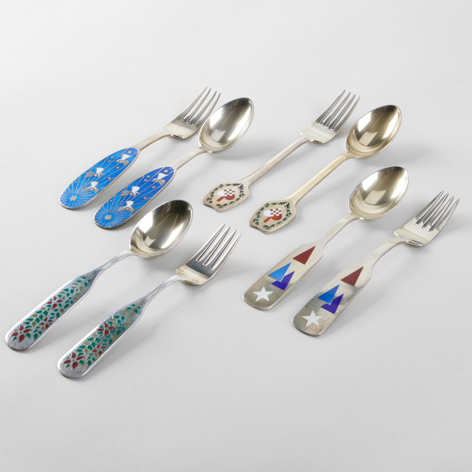 Set of Eight Jensen Silver and Enamel Commemorative Holiday Forks and Spoons: Set of Eight Jensen Silver and Enamel Commemorative Holiday Forks and Spoons Comprising: 1951 'Colorful Christmas' spoon and fork, designed by Eigil Jensen, mark of A. Michelsen and 'Sterling' 1953 'H