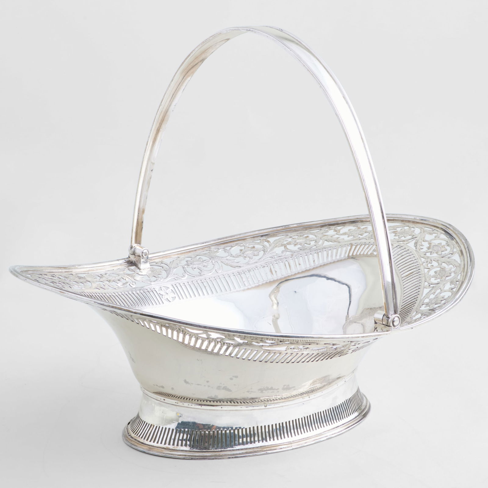 Scottish George III Silver Cake Basket: Scottish George III Silver Cake Basket Mark of Alexander Gardner, Edinburgh, 1792; engraved with armorial and motto 'Reparabit cornua phoebe'. 10 1/2 x 13 1/2 x 10 1/2 in., 29.7 oz. approx. gr