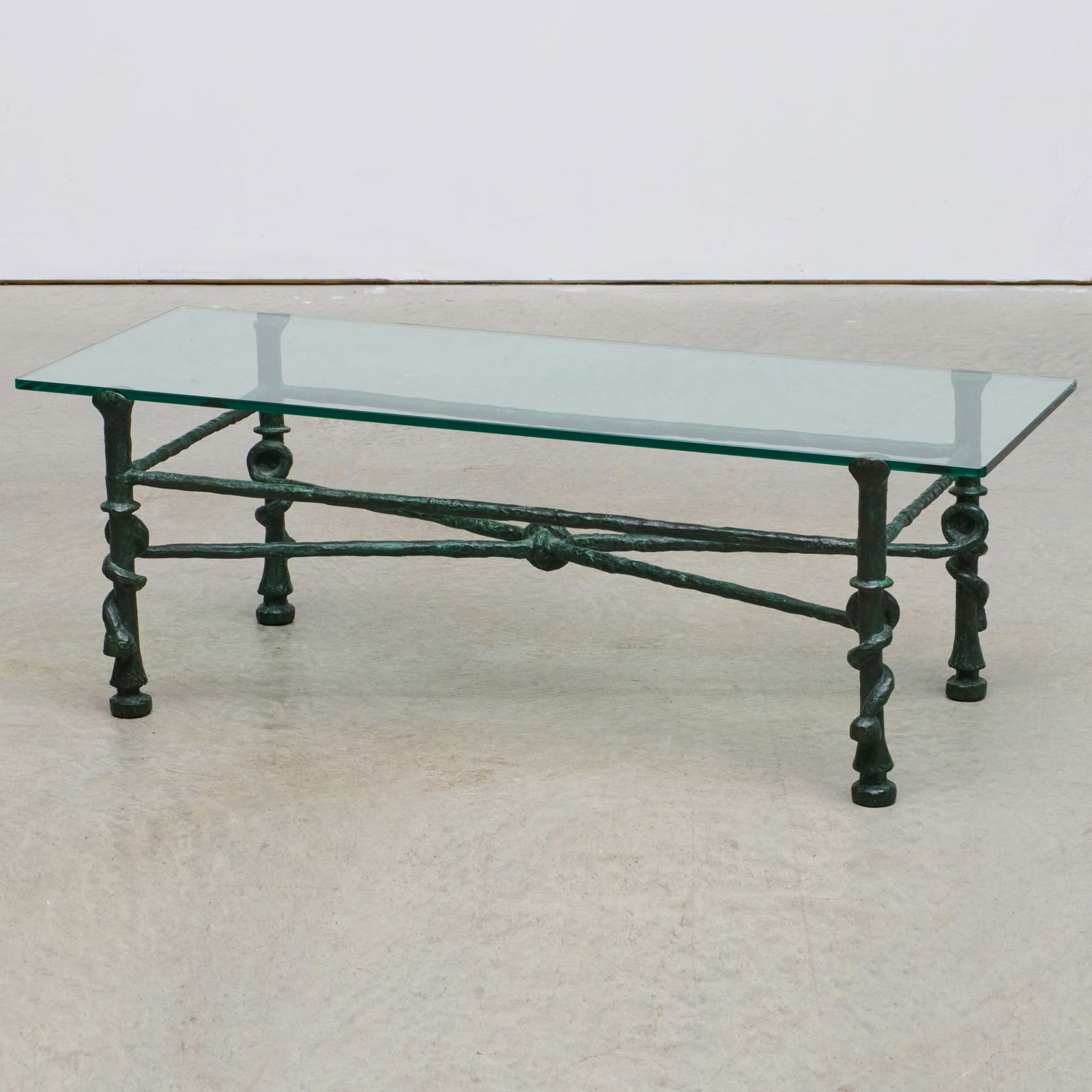 After Diego Giacometti (1902-1985): La Table Torsade: After Diego Giacometti (1902-1985): La Table Torsade Bronze and glass. With two spurious signatures. 15 3/4 x 46 x 17 1/2 in.By repute, Pierre Jacques Turgeon, 417 P. Bert, St. Ouen, France, acquired