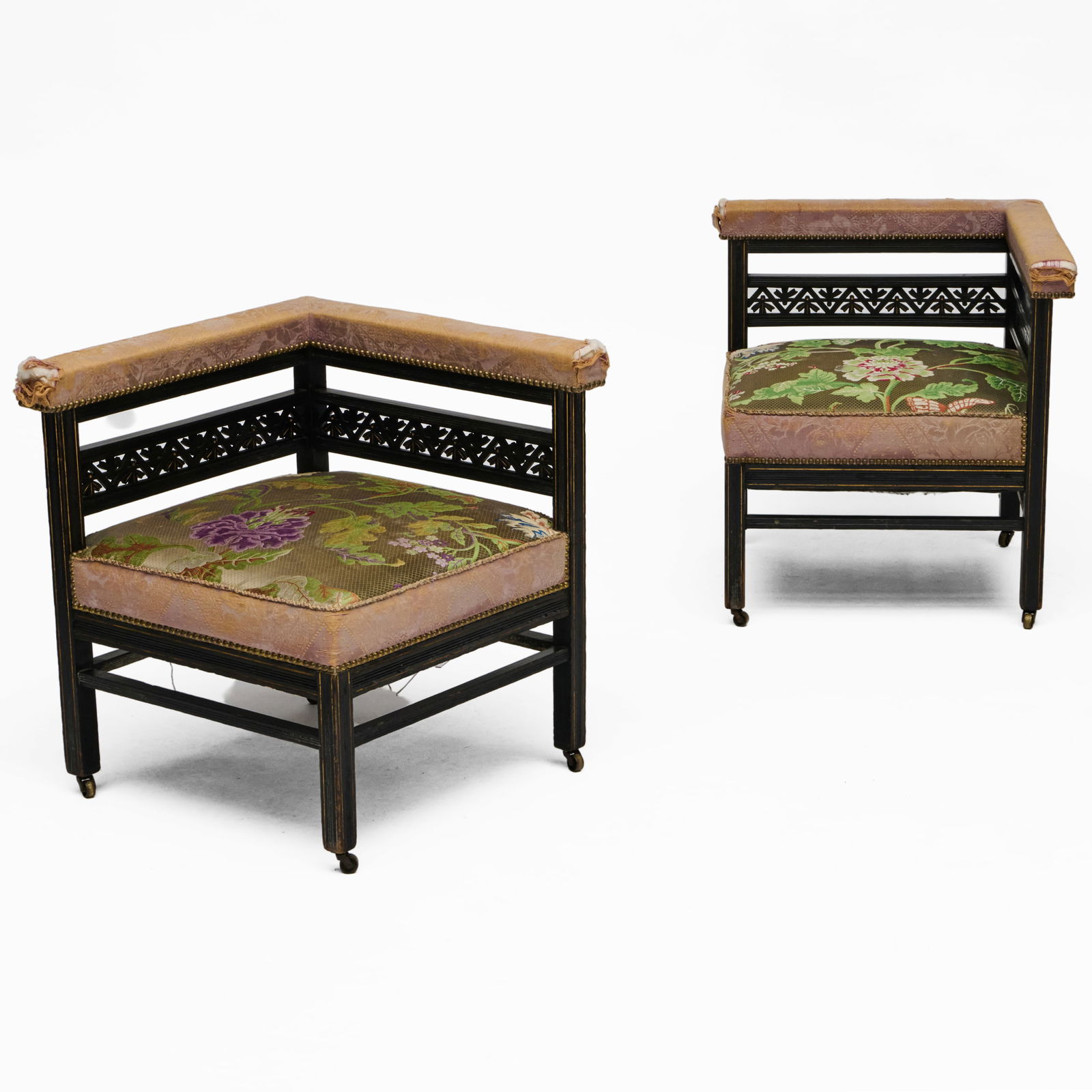 Pair of Aesthetic Movement Ebonized and Upholstered Corner Chairs: Pair of Aesthetic Movement Ebonized and Upholstered Corner Chairs Raised on casters. 26 x 24 x 24 in., seat height 16 in.