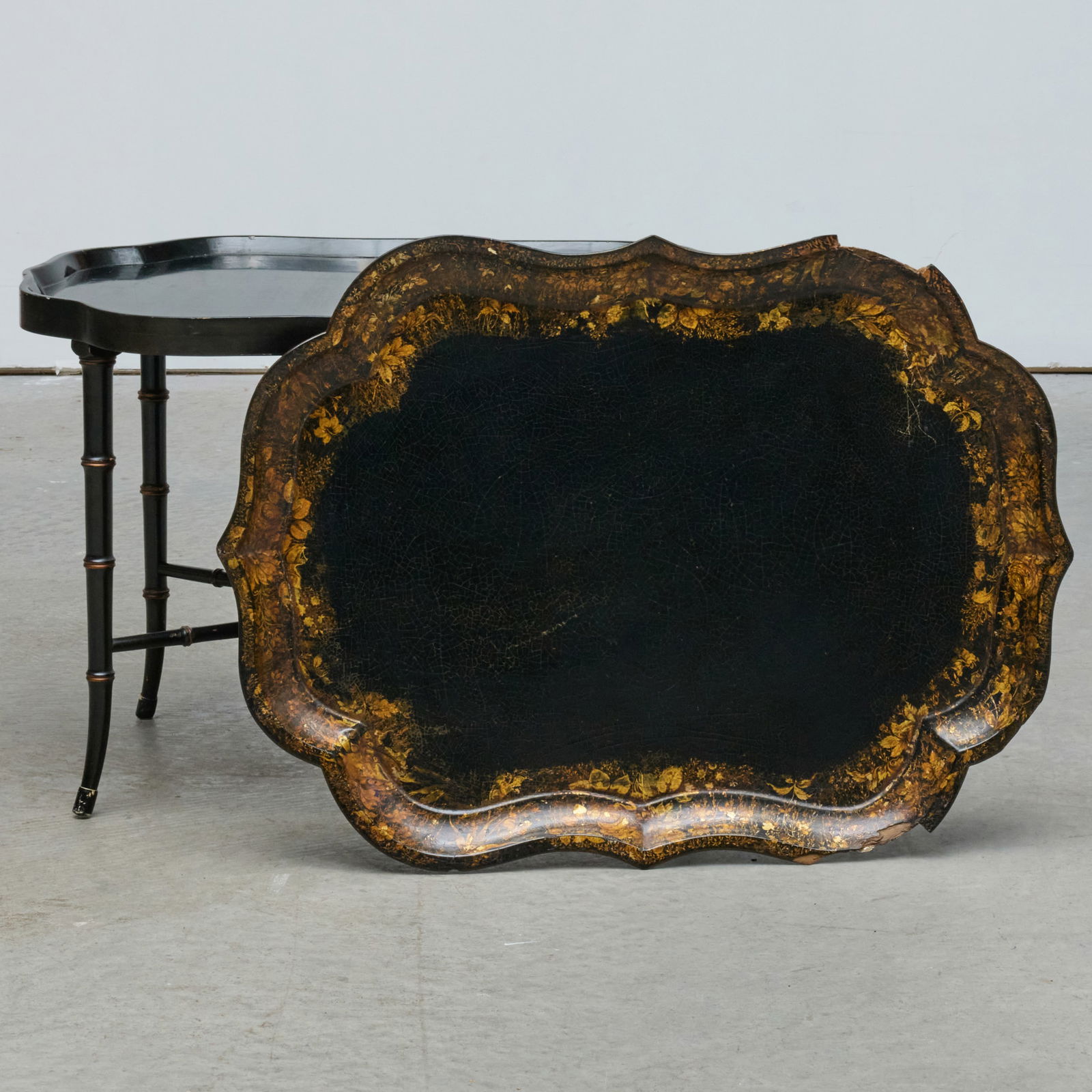 Victorian Black Lacquer and Parcel-Gilt Papier-Mache Tray on a Later Stand: Victorian Black Lacquer and Parcel-Gilt Papier-Mache Tray on a Later Stand Tray marked CLAY KING ST COVT GARDEN. 19 1/2 x 30 1/2 x 22 1/2 in. The Collection of Joel Shapiro.