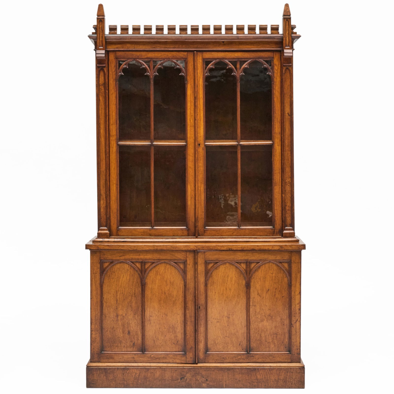 English Elm Gothic Bookcase: English Elm Gothic Bookcase In two parts, and the lower cabinet fitted with one shelf. 7 ft. 11 x 4 ft. 5 x 18 in. The Collection of Joel Shapiro.