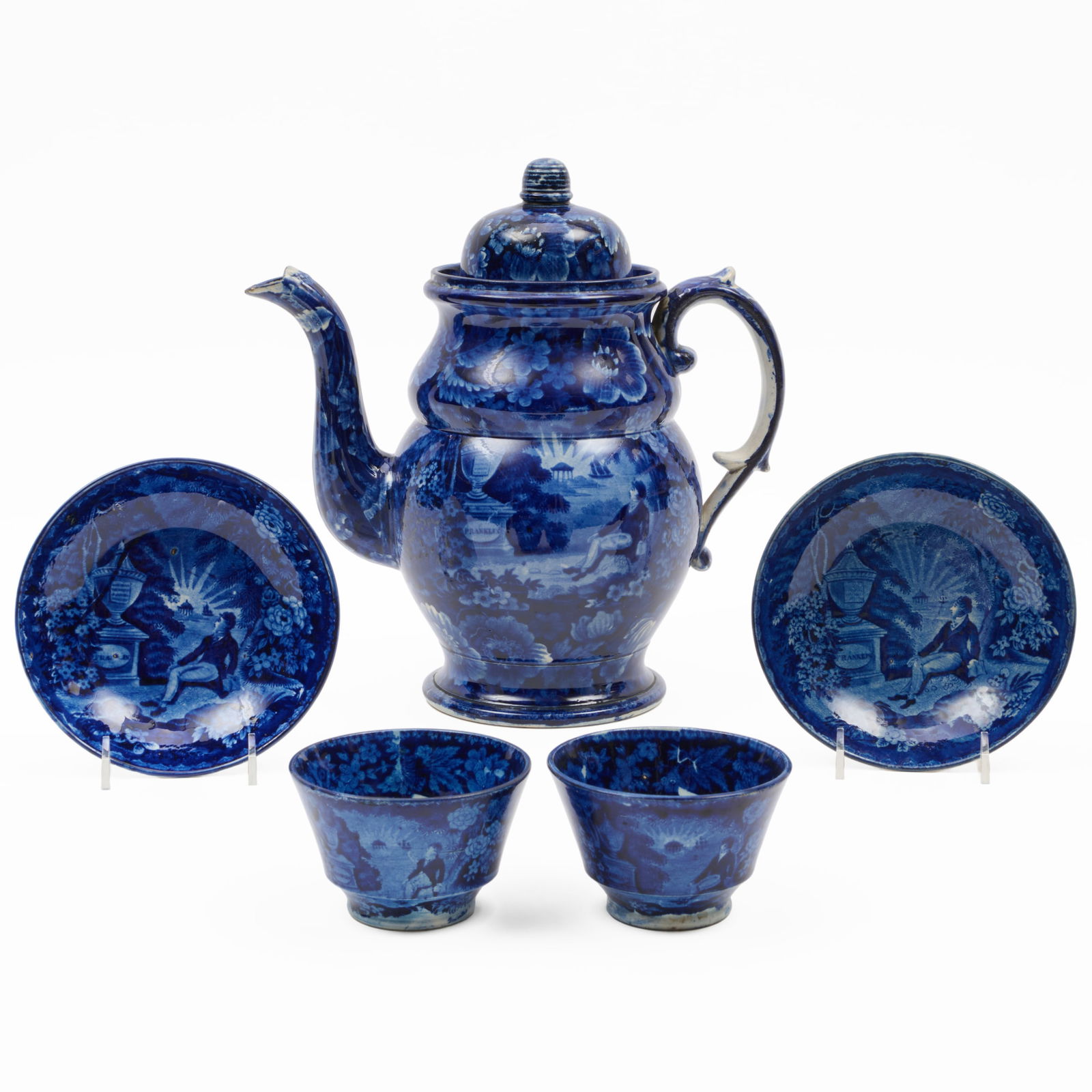 Enoch Wood Staffordshire 'Marquis de Lafayette at Benjamin Franklin's Tomb' Teapot and a Pair of: Enoch Wood Staffordshire 'Marquis de Lafayette at Benjamin Franklin's Tomb' Teapot and a Pair of Teabowls and Saucers The teapot and cover unmarked; the saucer with impressed marks. The teapot 10 3/4