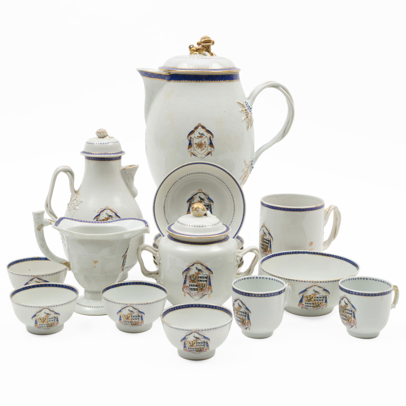 Chinese Export Armorial Porcelain Part Service: Chinese Export Armorial Porcelain Part Service Unmarked. Comprising: A punch pot and cover A hot water jug with an associated cover A sugar bowl and cover A helmet shaped jug A mug Four teabowls <