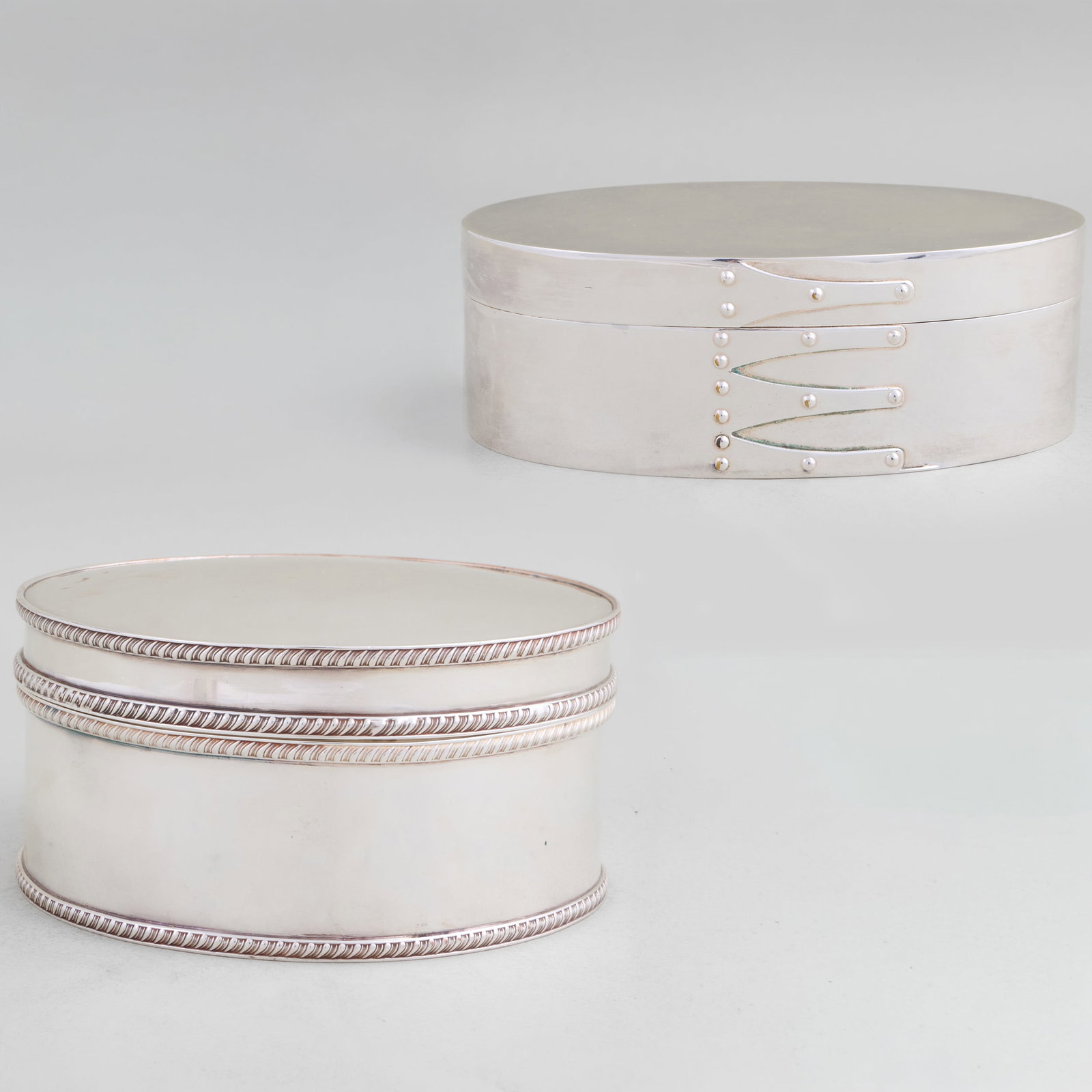 Portuguese Silver Plate Shaker Style Box and Circular Silver Plate Box: Portuguese Silver Plate Shaker Style Box and Circular Silver Plate Box The shaker style 2 1/4 x 6 1/2 x 4 in., the circular 2 5/8 x 6 in. diam. The Miller Family Collection, Pittsfield, MA.
