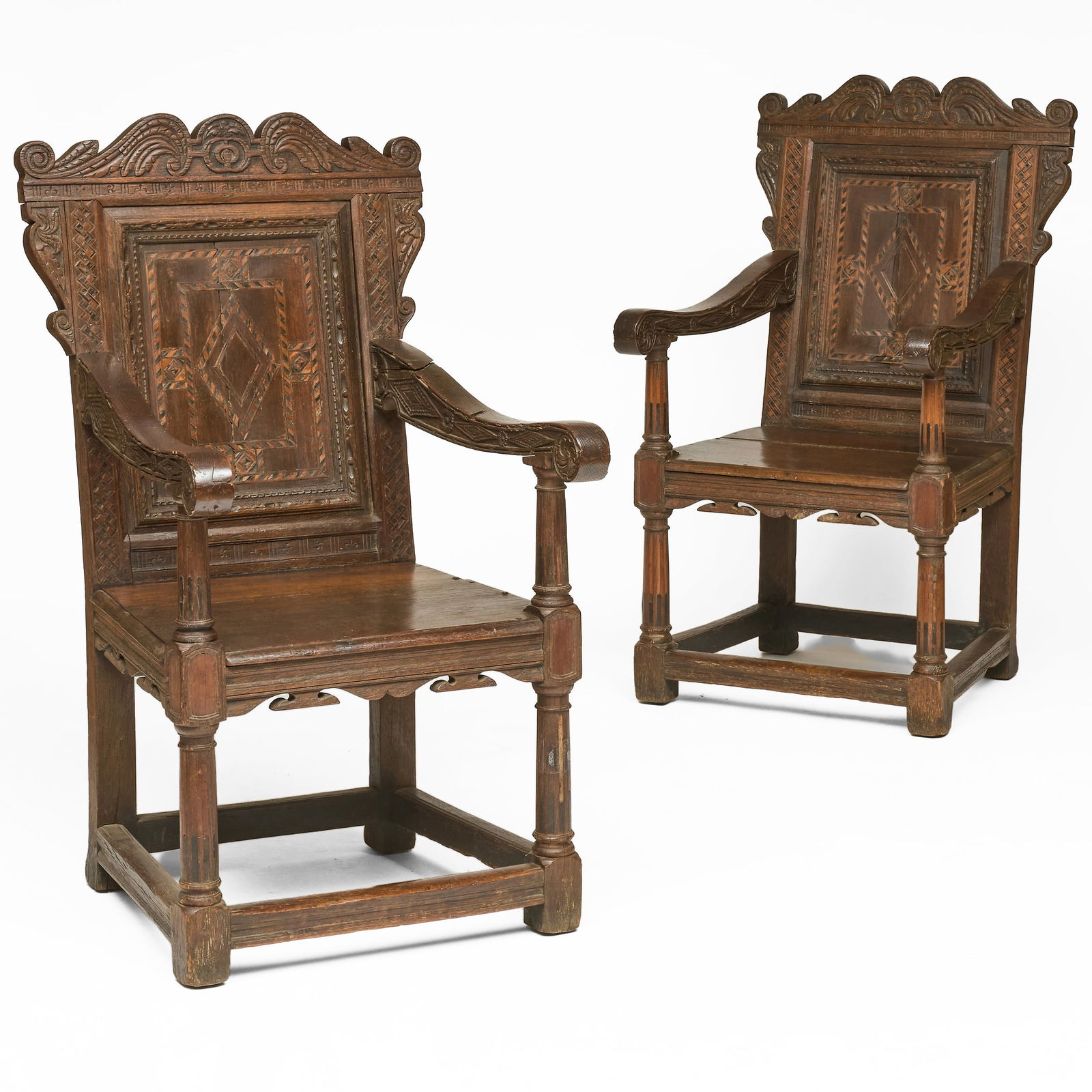Pair of Charles I Carved and Inlaid Oak Wainscot Chairs: Pair of Charles I Carved and Inlaid Oak Wainscot Chairs Both with plaques on the reverse of the back inscribed with "Presented by EFS 1745 FWB." 47 1/2 x 25 1/2 x 31 in., seat height 19 in. Property f