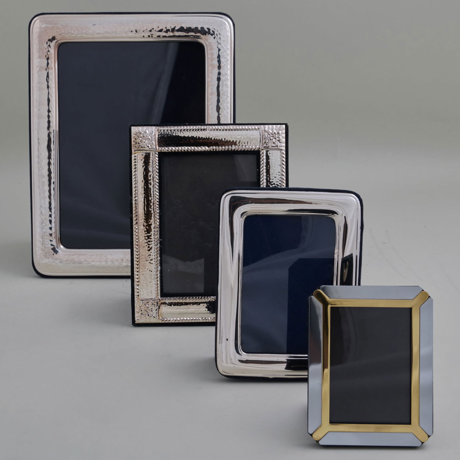 Group of Four Silver and Silver Plate Picture Frames: Group of Four Silver and Silver Plate Picture Frames The silver comprising: A rectangular frame, marked '.925' The silver plate comprising: A two-toned frame A frame with corner flower sprays A planis