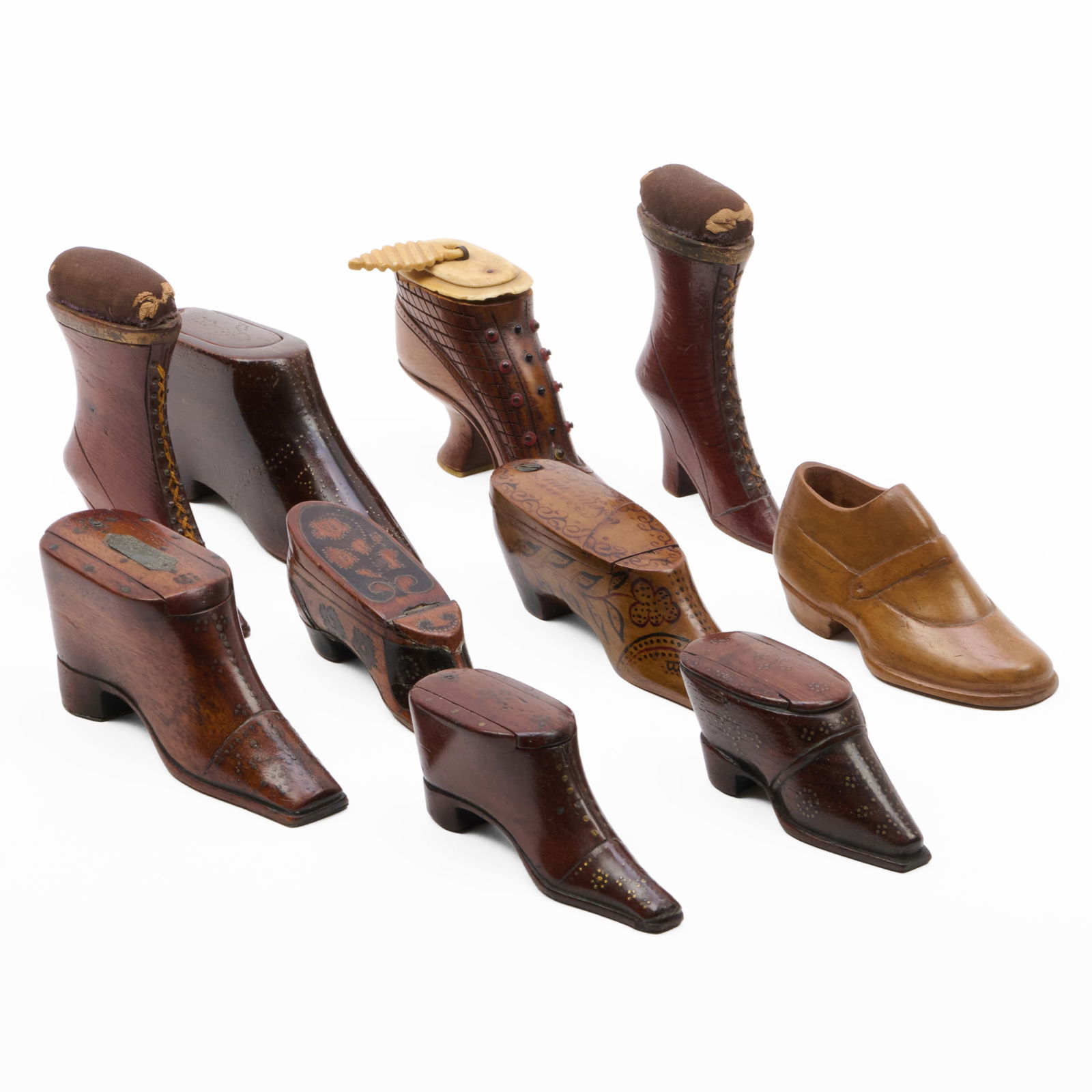 Group of English Treen Shoe and Boot-Form Snuffboxes: Group of English Treen Shoe and Boot-Form Snuffboxes Together with two pincushions. The largest 2 1/4 x 5 x 1 1/4 in. The smallest 1 1/2 x 3 1/2 x 1 1/4 in. Property from the Collection of a Prominent