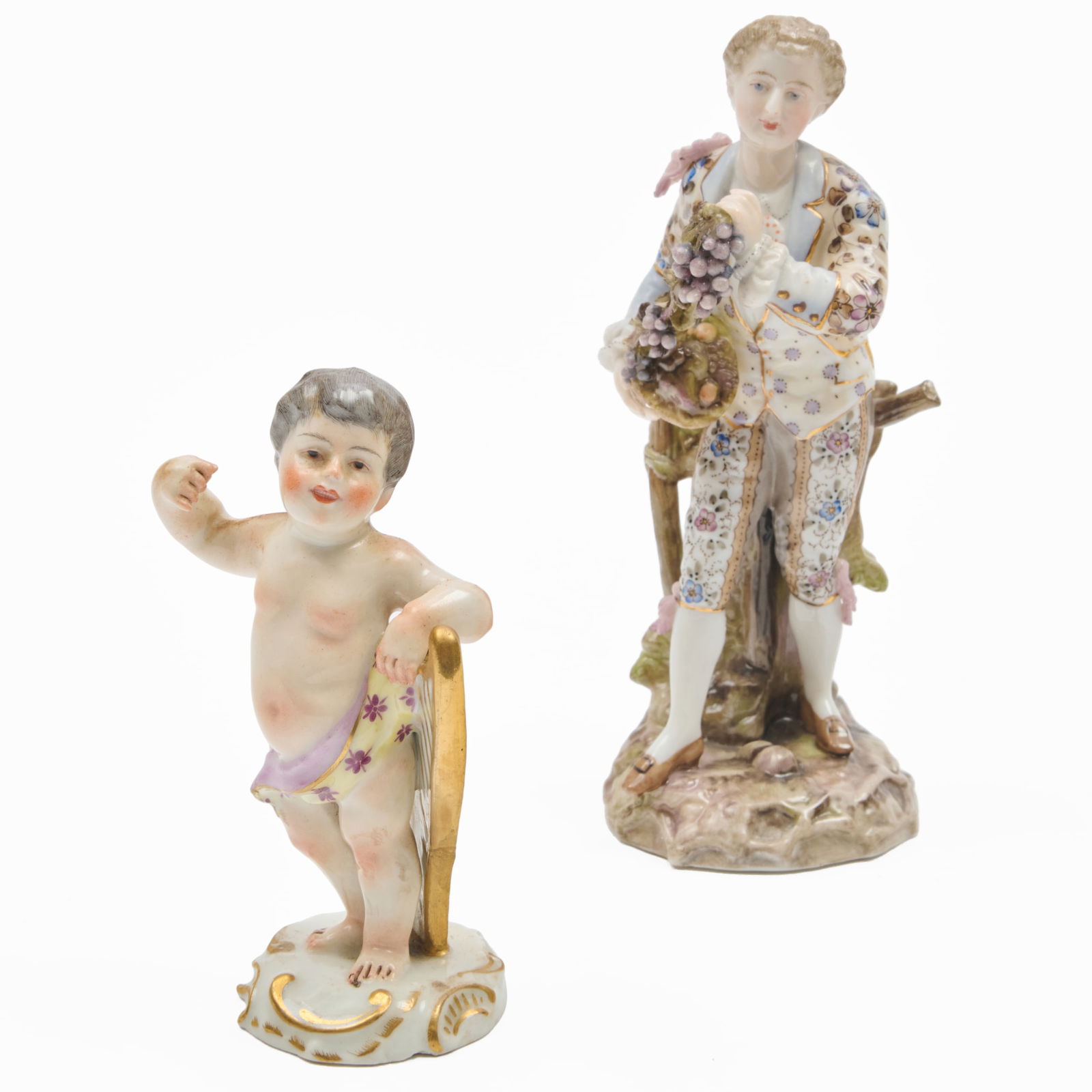 Volkstedt Porcelain Figure with Grapes and a Continental Porcelain Putto with a Harp: Volkstedt Porcelain Figure with Grapes and a Continental Porcelain Putto with a Harp The first underglaze blue mark; the second?blue crossed swords mark The figure with grapes 6 1/4 x 2 1/4 x 2 1/2 in