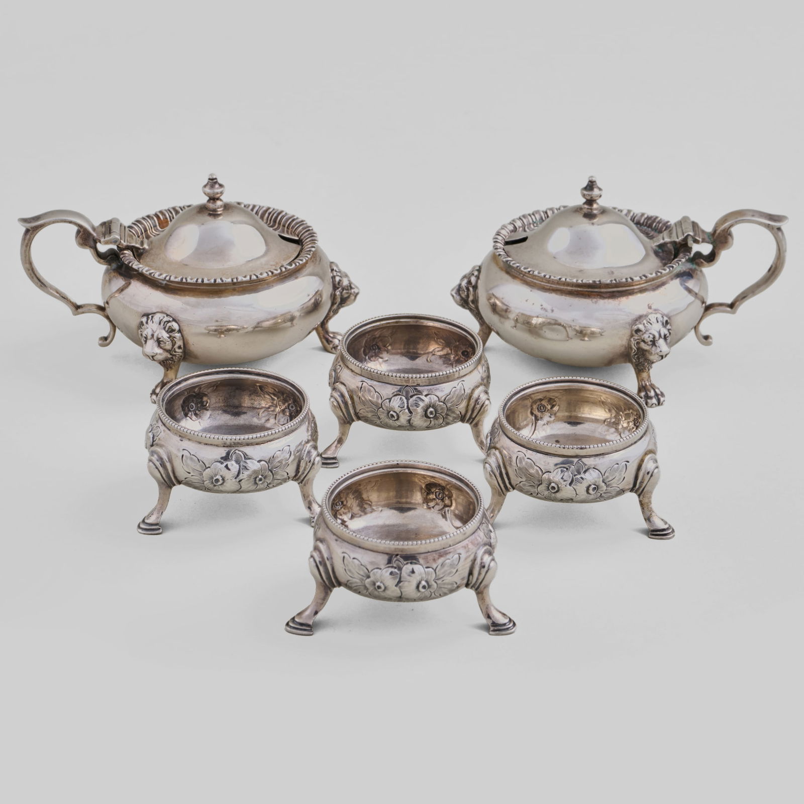 Group of Victorian and George V Silver Condiment Wares: Group of Victorian and George V Silver Condiment WaresComprising:A pair of mustard pots with blue glass liners, mark of Dibdin & Co Ltd, London, 1933A set of four salt cellars, mark of Arthur Sibley,