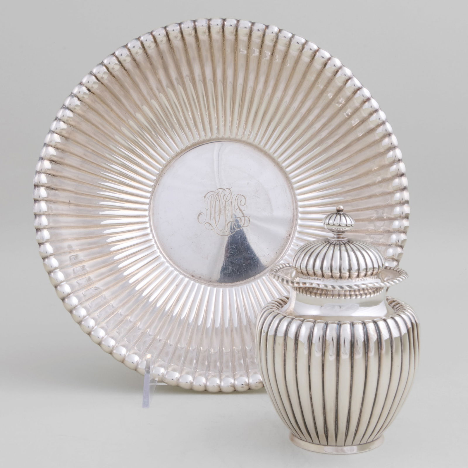 Two American Silver Fluted Articles: Two American Silver Fluted ArticlesMarked 'Sterling'.Comprising:A Reed & Barton bowl, monogrammed, inscribed 'April 19, 1952'A Dominick & Haff tea caddy and coverThe bowl 3 x 9 3/4 in. diam., 24.7