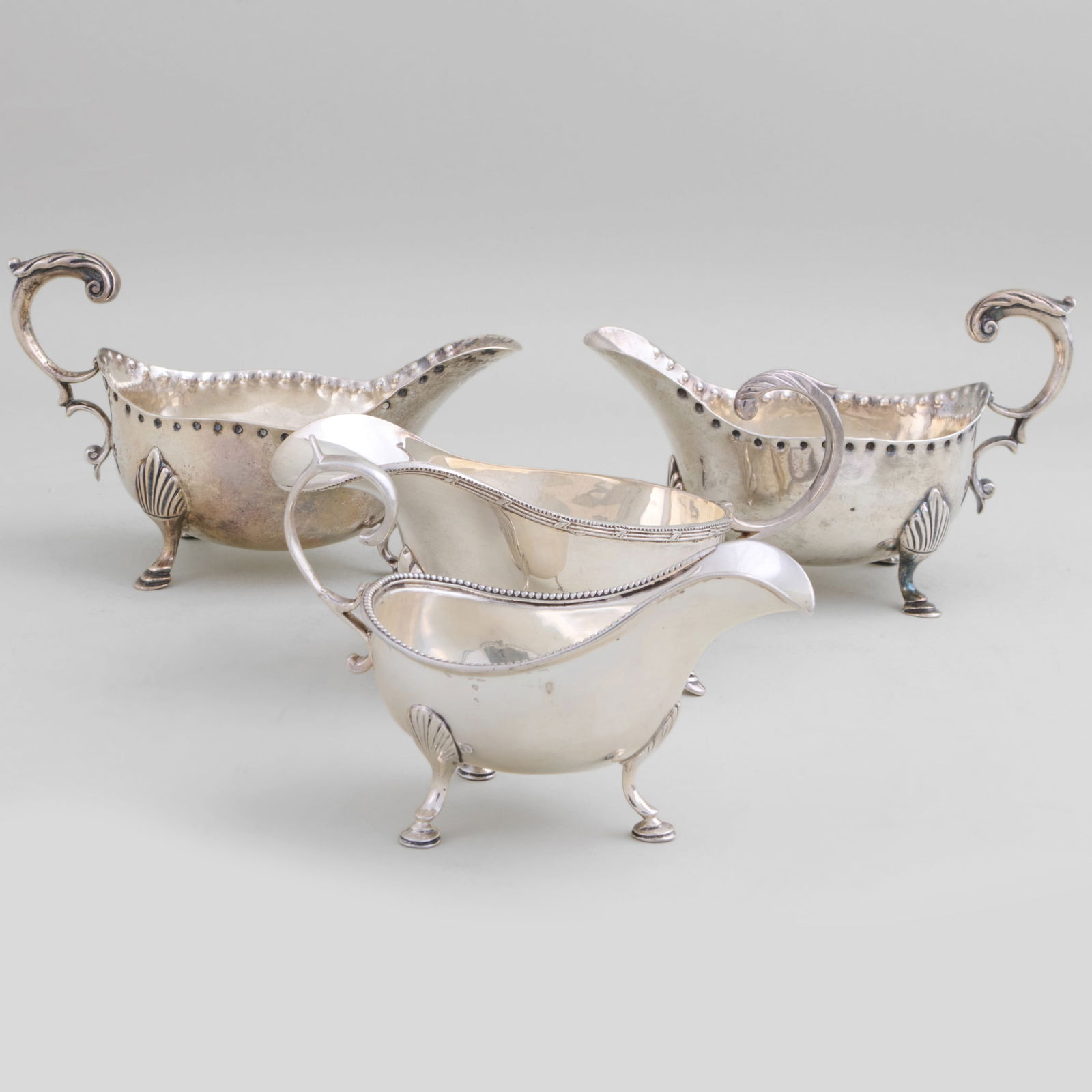 Group of Three George III Silver Sauceboats: Group of Three George III Silver SauceboatsComprising:A pair of sauce boats, mark of John Schofield, London, 1804A smaller sauce boat, mark of William Cattell,?London, 1783Together with a silver
