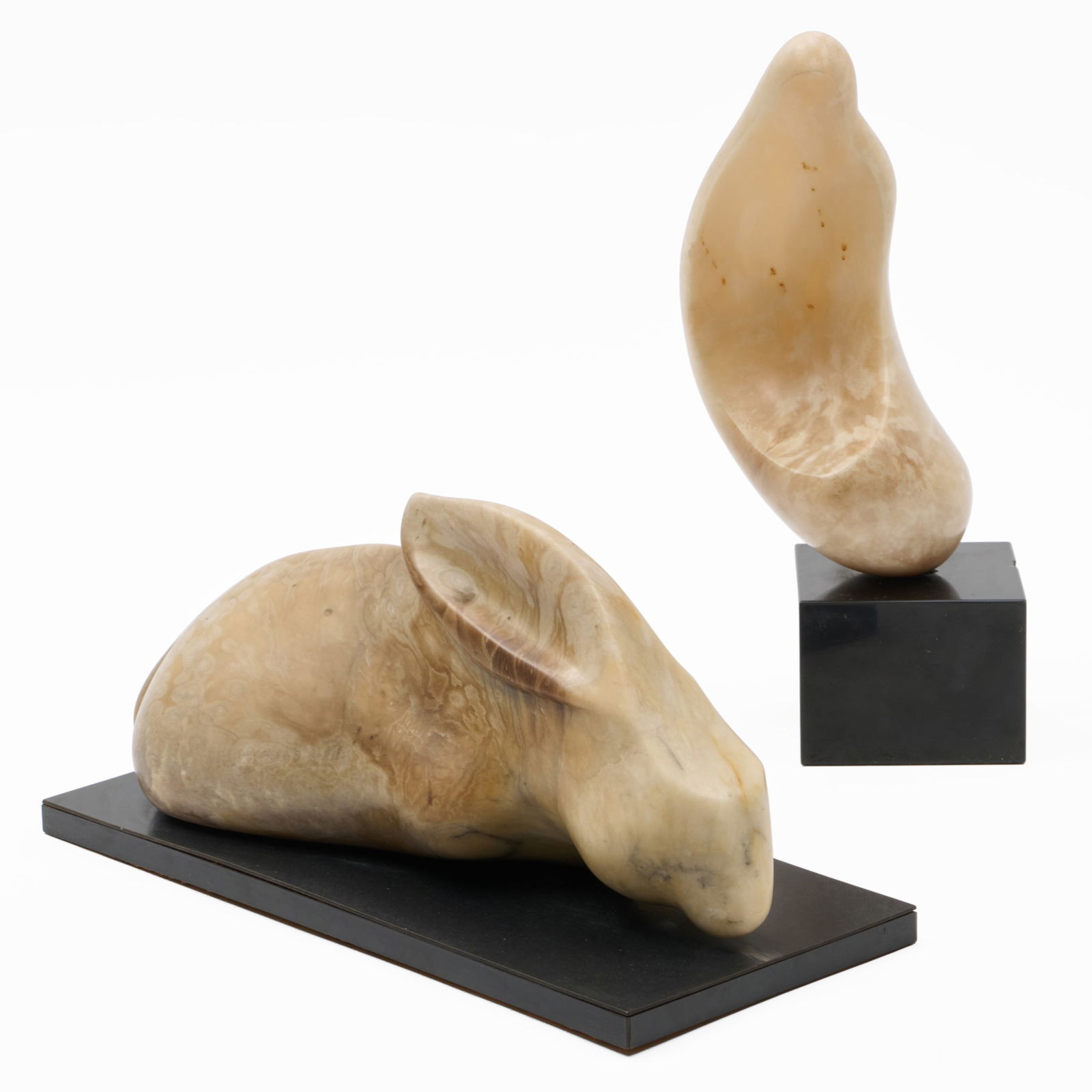 Lynn Chase (1948-2025): Sheep on the Desert; and Rabbit: Lynn Chase (1948-2025): Sheep on the Desert; and RabbitTwo agate sculptures on black composite bases, both unmarked.13 1/2 x 7 x 5 in., with base, 8 x 14 1/2 x 6 1/2 in., with base.Collection of Lynn