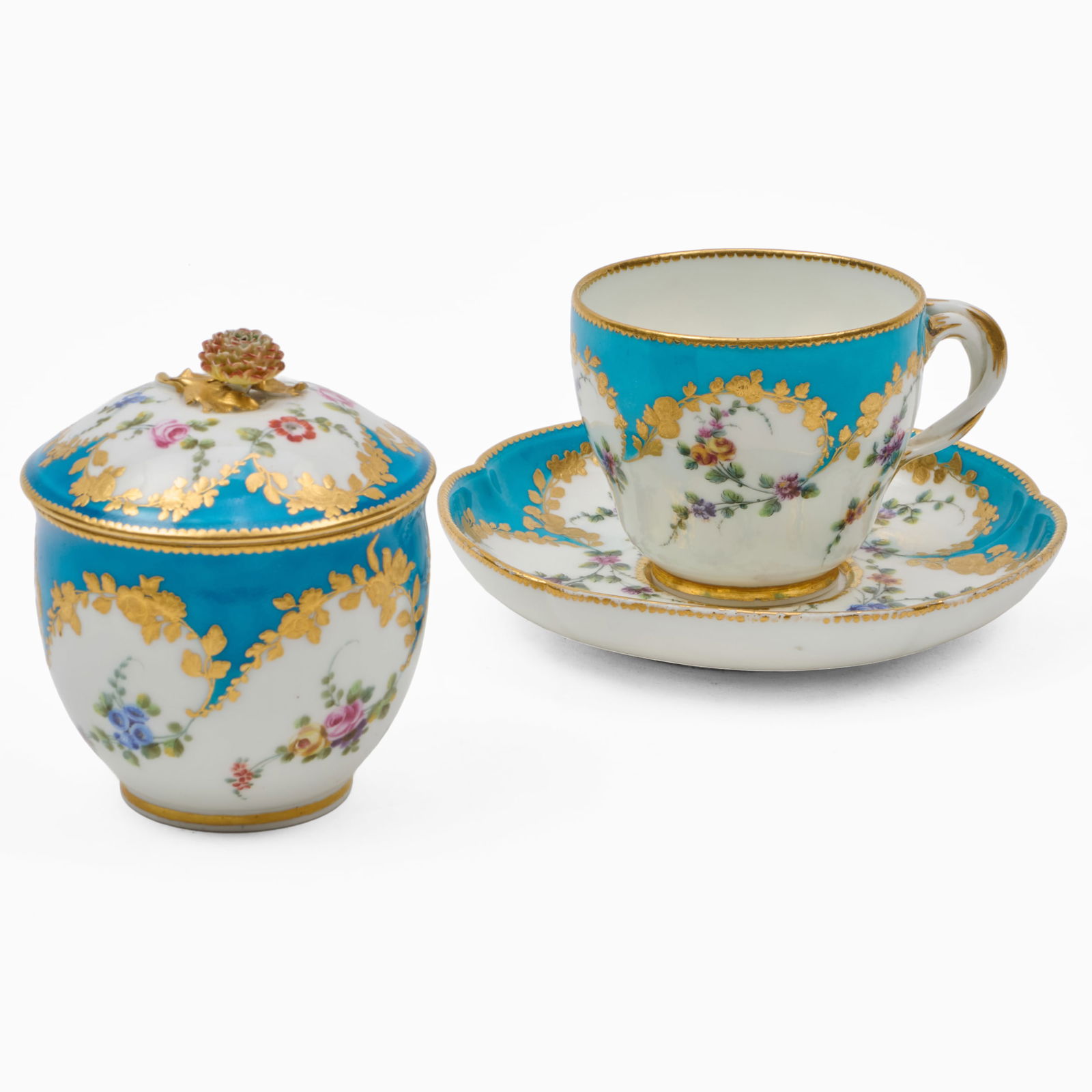 Sevres Blue Ground Porcelain Teacup and Saucer and a Sugar Bowl and Cover: Sevres Blue Ground Porcelain Teacup and Saucer and a Sugar Bowl and CoverBlue painted interlaced L marks.The teacup and saucer 3 x 5 1/2 in. diam., the sugar bowl 3 3/4 x 3 1/4 in. diam.Collection of