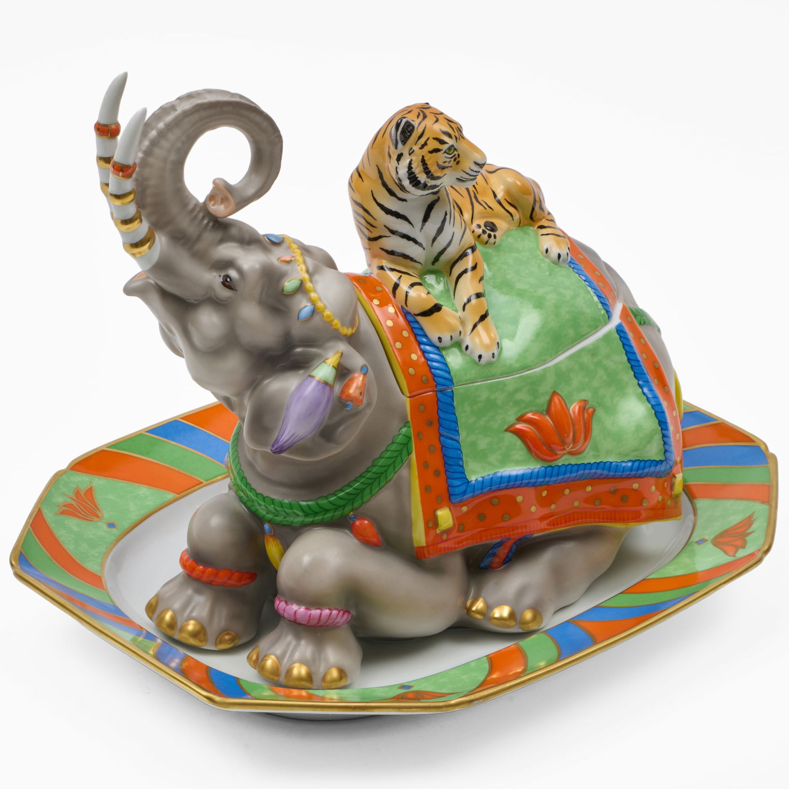 Lynn Chase Porcelain Tureen, Cover and Underplate in the 'Tiger Raj' Pattern: Lynn Chase Porcelain Tureen, Cover and Underplate in the 'Tiger Raj' PatternPrinted marks.The tureen 11 1/2 x 14 x 7 1/2 in., the underplate 12 3/4 x 15 3/4 in.Collection of Lynn Chase from Money Pit