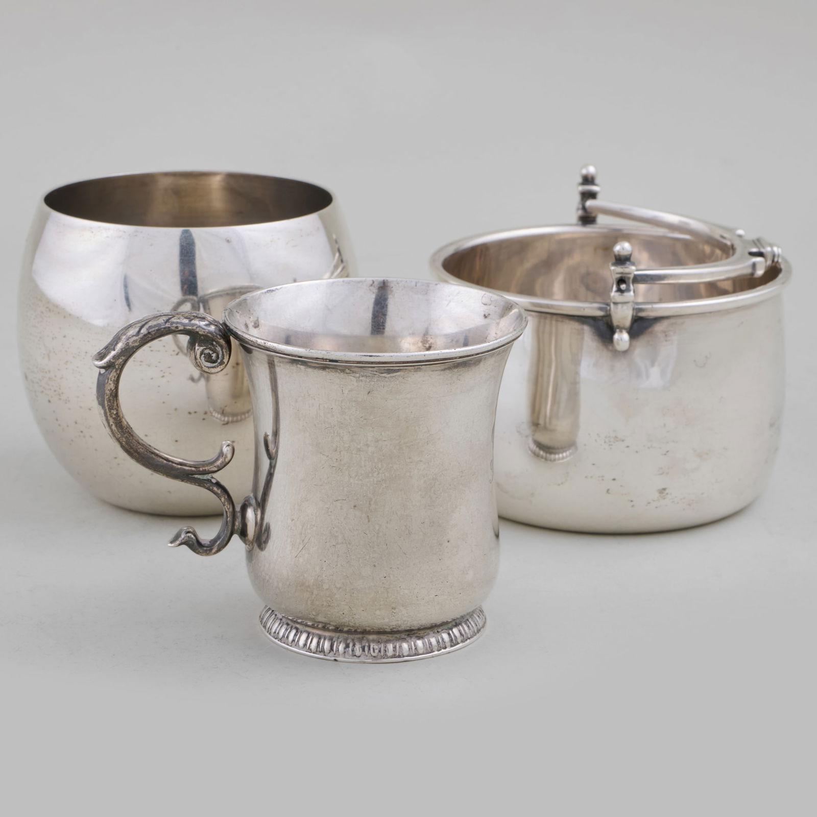 Two Tiffany & Co. Silver Cups and a Tane Silver Basket: Two Tiffany & Co. Silver Cups and a Tane Silver Basket Each marked 'Sterling'. The cups comprising: A baby mug, inscribed 'Edith from Grandma, 1907' A tumbler The largest 3 x 3 1/4 in. diam., 18.6 oz.
