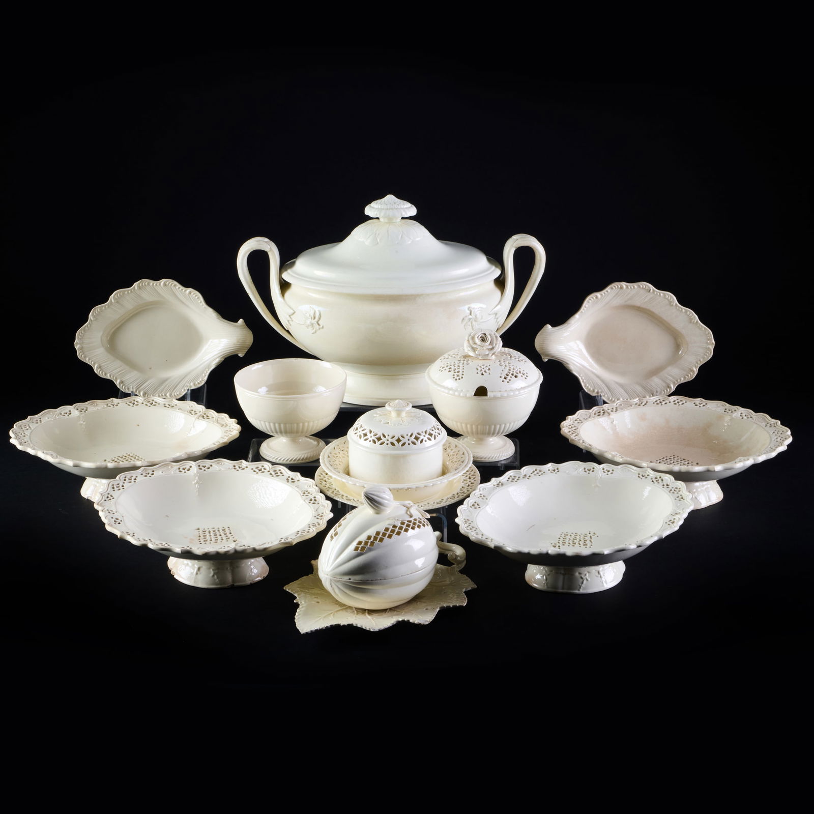 Group of English Creamware: Group of English CreamwareUnmarked. Comprising: A two handle tureen and cover A pair of footed circular bowls and one reticulated cover A melon form box and cover A circular box and reticulated cover