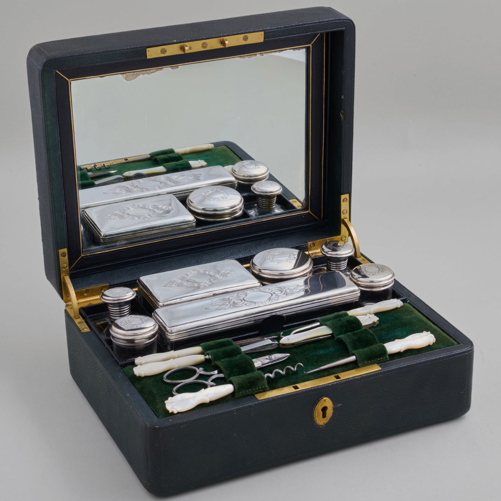 Continental Leather and Brass-Mounted Toilette Set: Continental Leather and Brass-Mounted Toilette SetInterior fitted with various implements.The case 4 1/4 x 10 1/4 x 7 3/4 in.