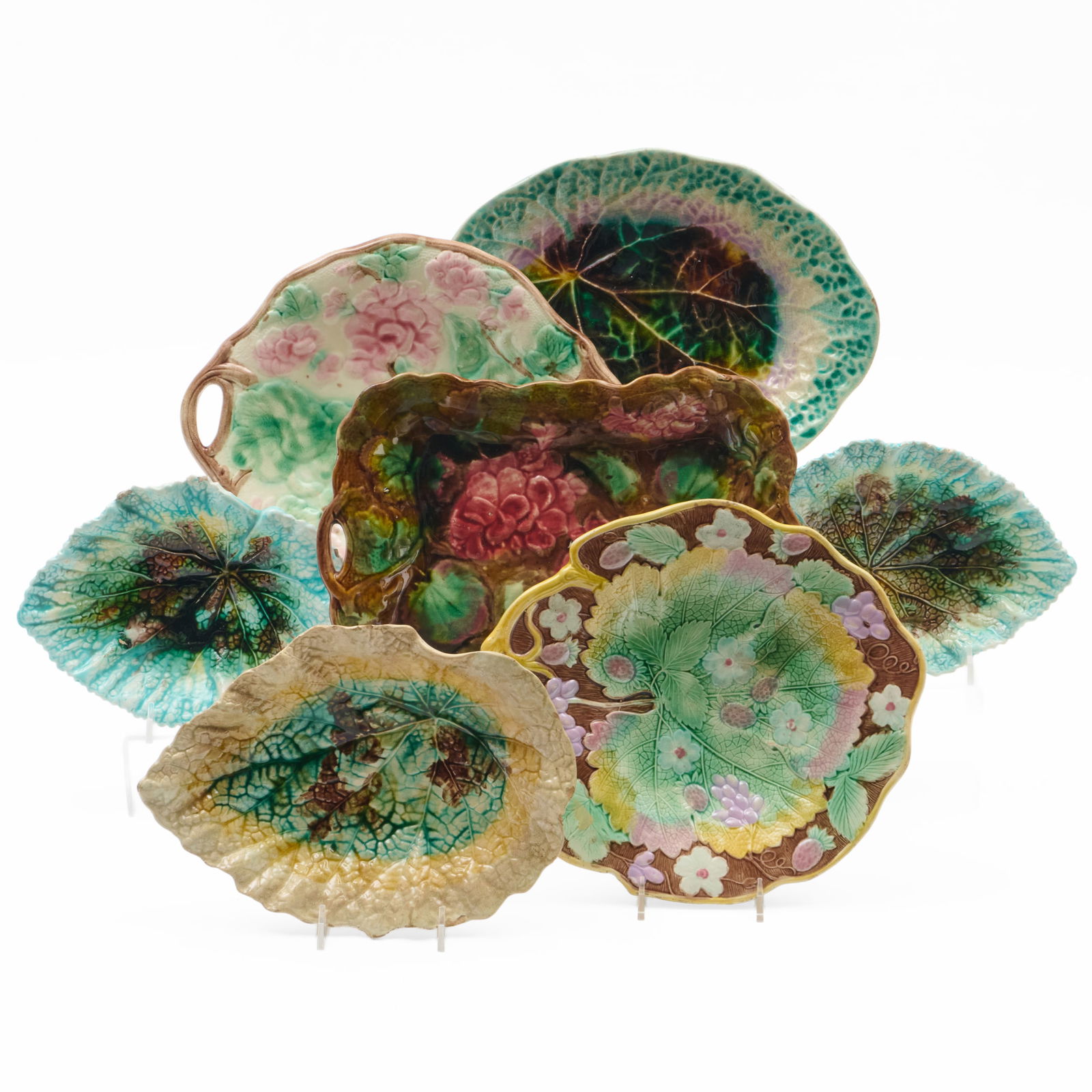 Group of Six Majolica Begonia Wares: Group of Six Majolica Begonia WaresUnmarked.Comprising:A circular two handle tray with pink and green decorationA brown glazed two handle rectangular tray with pink and green decorationA leaf shape