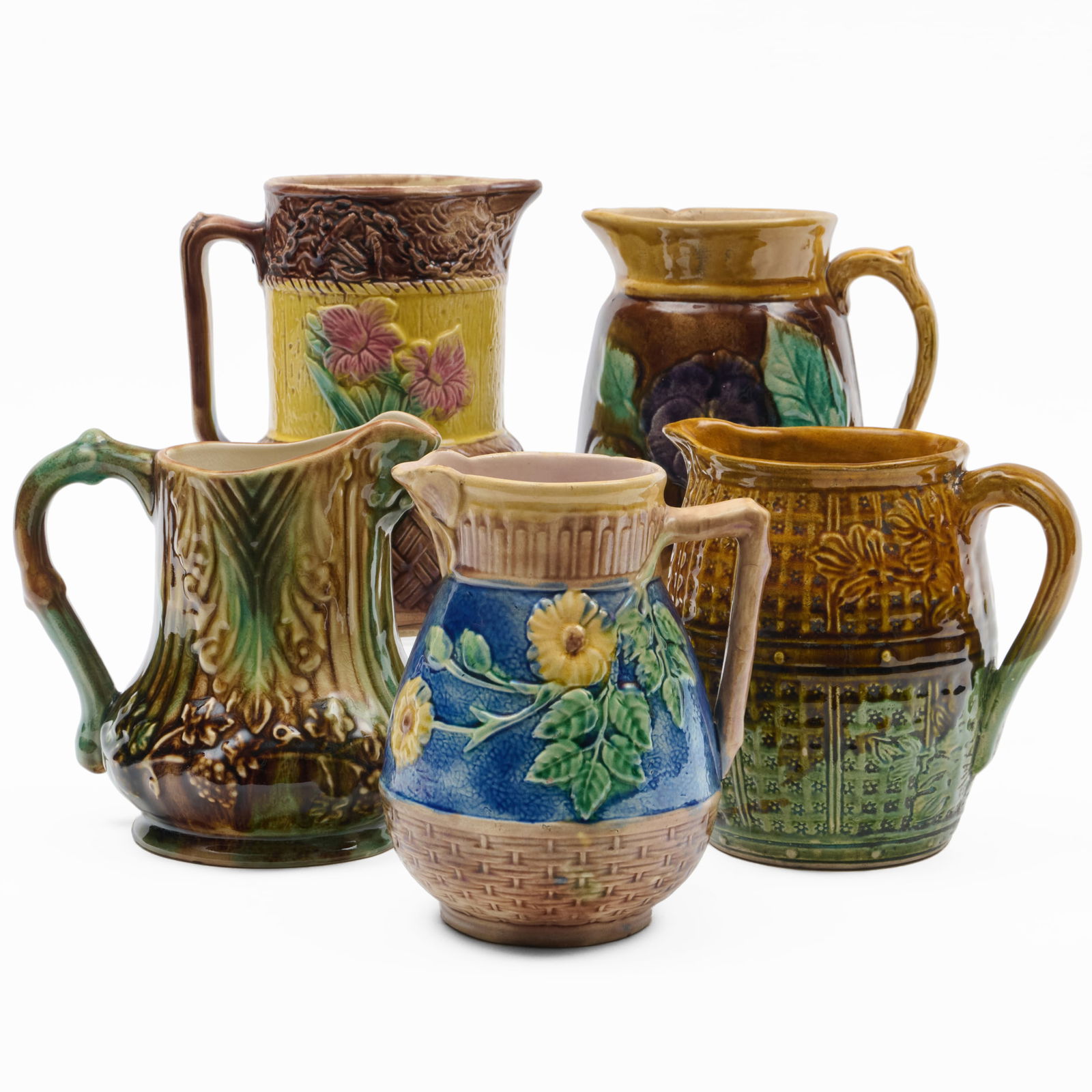 Group of Five Majolica and Majolica Style Pitchers: Group of Five Majolica and Majolica Style Pitchers Some with impressed and incised marks. The tallest 8 1/2 x 7 x 5 in., the shortest 7 x 6 x 5 in., (5 pcs). The Collection of Alan and Marilyn Bergman