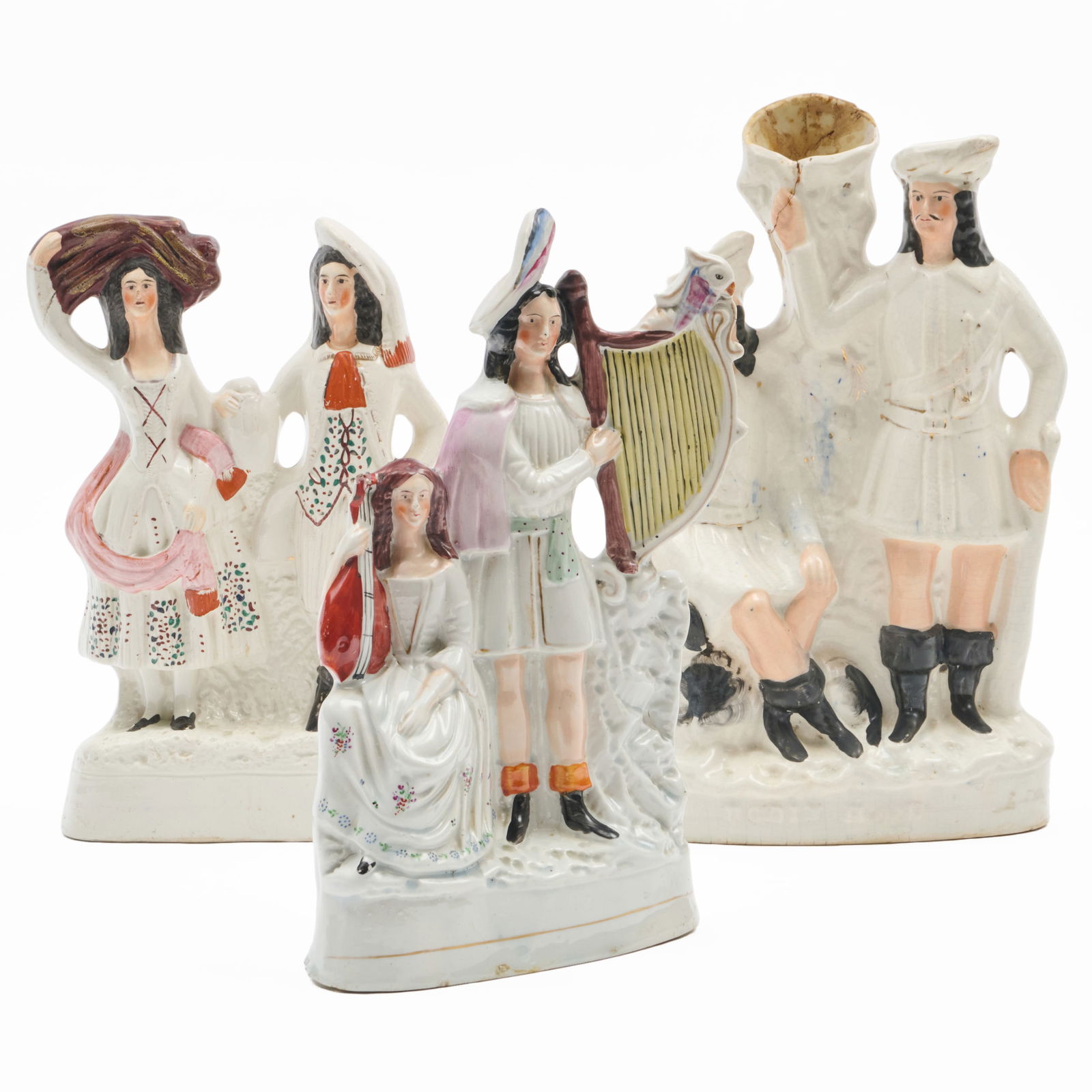 Group of Three Staffordshire Figure Groups: Group of Three Staffordshire Figure GroupsUnmarked.Comprising:A spill vase with two men and a spanielA group of musicians A group of dancersThe spill vase 15 x 10 x 3 in., the group of musicians 12