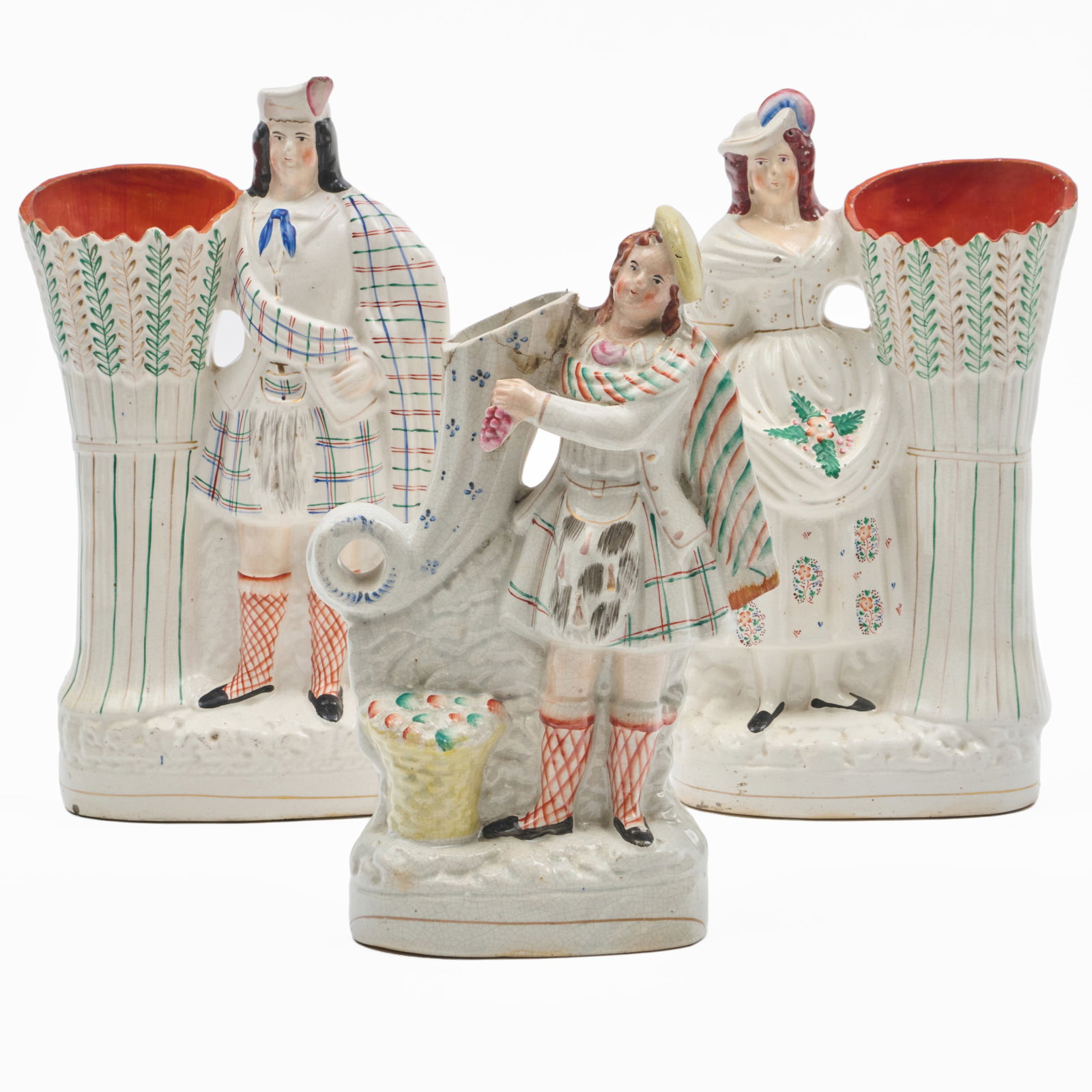 Group of Three Figural Staffordshire Spill Vases: Group of Three Figural Staffordshire Spill VasesUnmarked.Comprising:A large pair of spill vasesA spill vase with ScotsmanThe pair 14 1/2 x 8 x 3 in., the single 12 1/2 x 8 x 2 1/2 in., (3 pcs).The