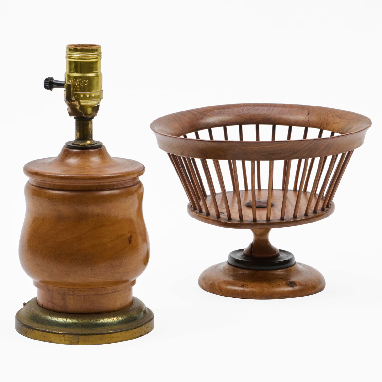 Treen and Brass Table Lamp and a Wood Fruit Bowl: Treen and Brass Table Lamp and a Wood Fruit Bowl The lamp 10 x 5 in. diam., the sewing basket 6 3/4 x 8 3/4 in. The Collection of Alan and Marilyn Bergman.