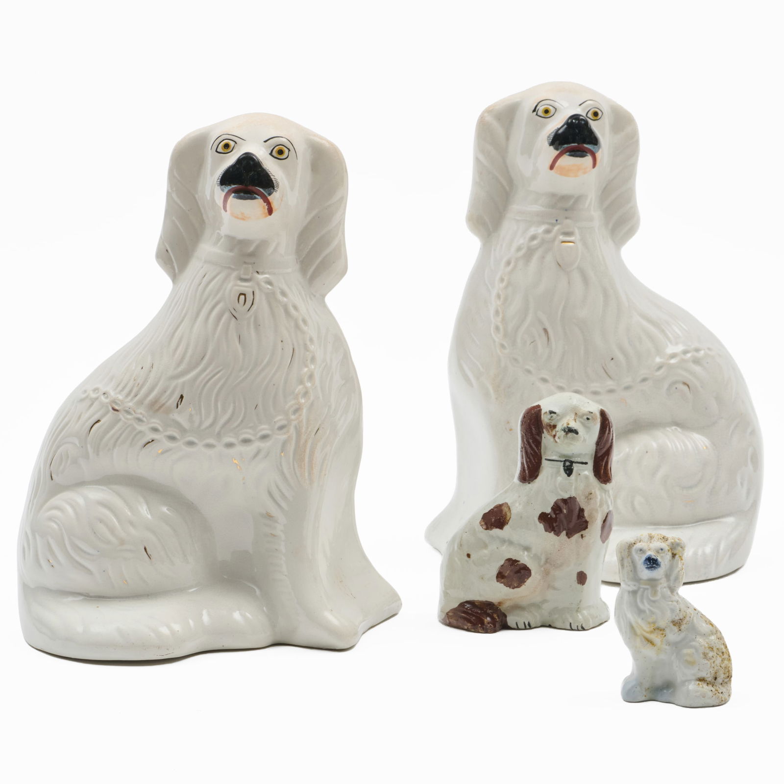 Group of Four Staffordshire Models of Spaniels: Group of Four Staffordshire Models of Spaniels Unmarked.Comprising:A large pair of white glazed and gilt spanielsA brown and white glazed spanielA small white glazed spanielThe pair 12