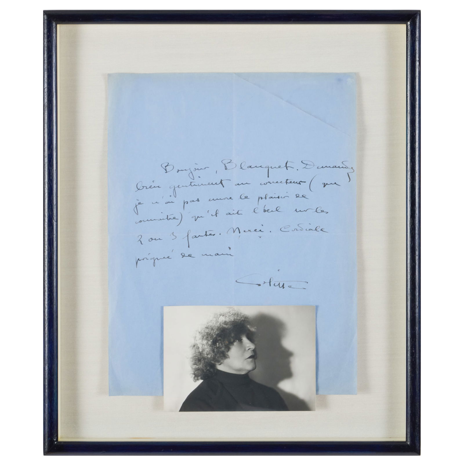 Handwritten Letter from Colette: Handwritten Letter from Colette Handwritten note on blue paper with attached photograph. 11 x 8 in. (sheet with photo), 14 1/2 x 12 1/2 in. (frame). Note: This signature has not been authenticated. Th