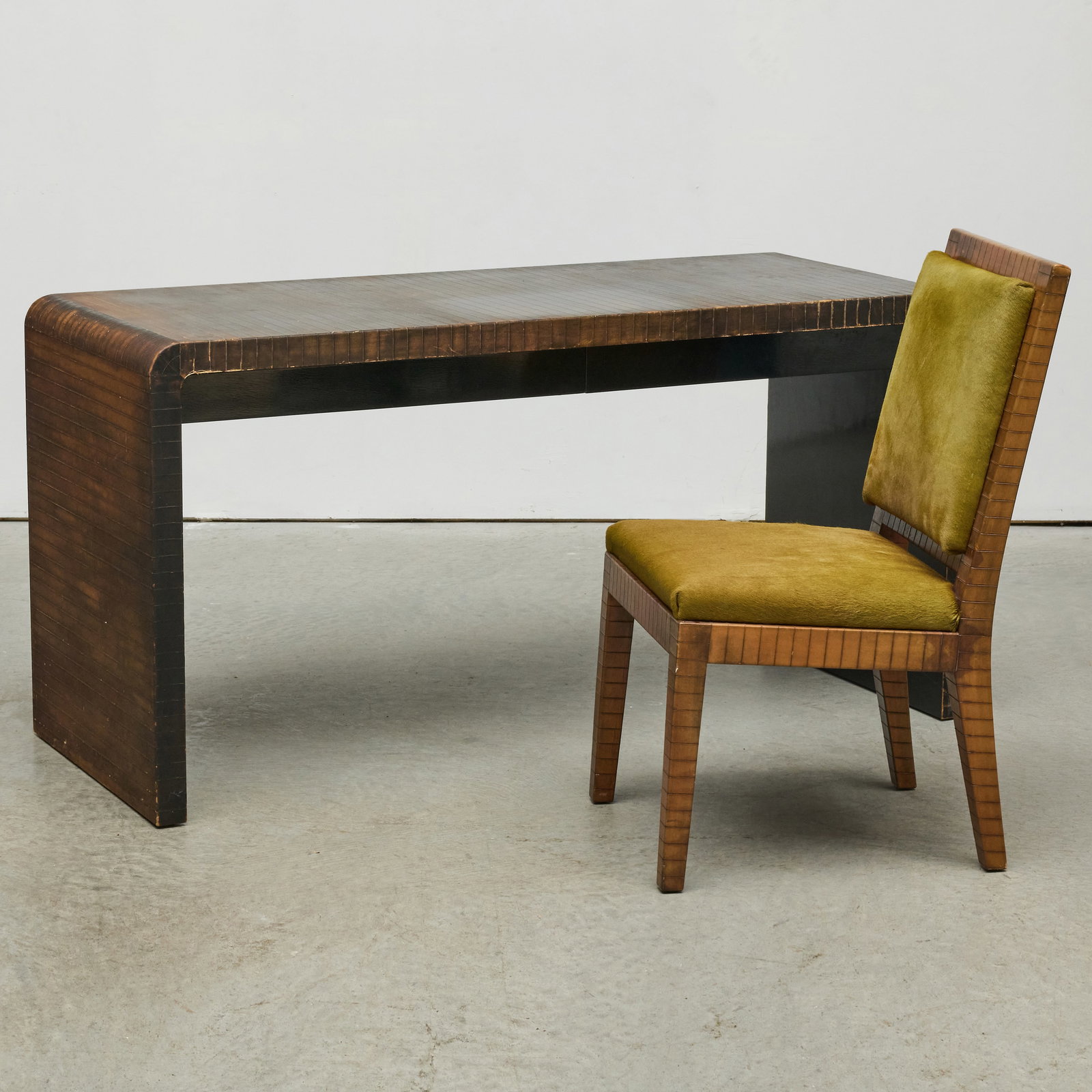 Leather-Covered and Black Lacquered Wood Desk Suite in the Manner of Karl Springer: Leather-Covered and Black Lacquered Wood Desk Suite in the Manner of Karl Springer The chair 36 1/4 x 19 1/4 x 22 in., seat height 18 in. The desk 30 1/2 x 5 ft. x 24 1/4 in.
