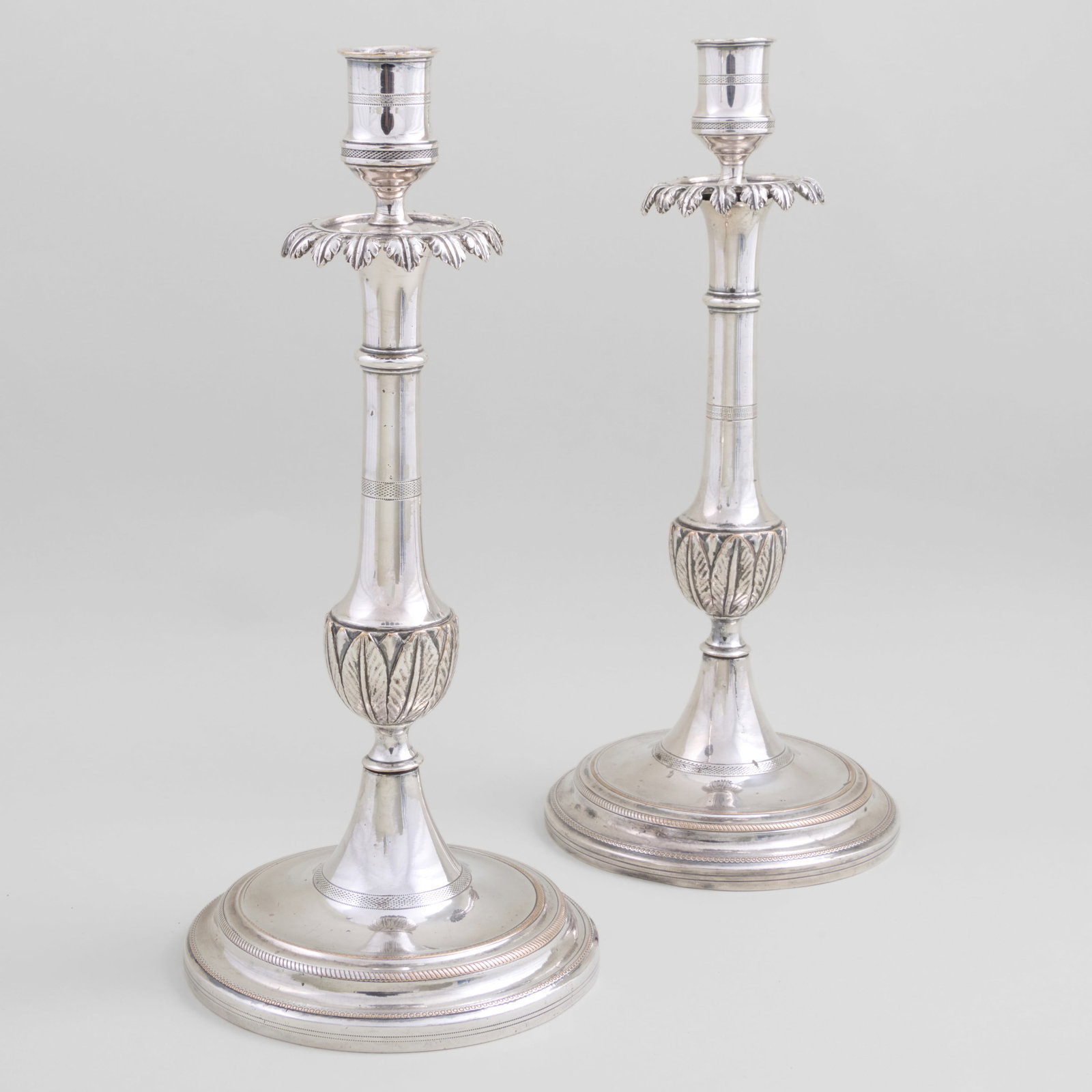 Pair of Christofle Silver Plate Candlesticks: Pair of Christofle Silver Plate Candlesticks 12 1/4 x 5 1/2 in. diam. Collection of Nancy McClelland.
