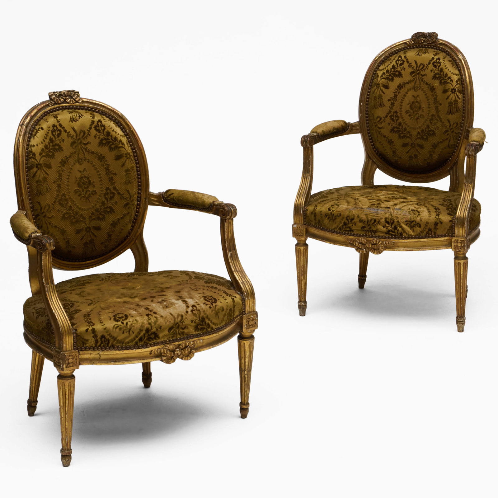 Louis XVI Giltwood Fauteuil en Cabriolet, Together With a Later Copy: Louis XVI Giltwood Fauteuil en Cabriolet, Together With a Later Copy 34 1/2 x 23 x 24 in., seat height 16 in., the other seat height 15 in.
