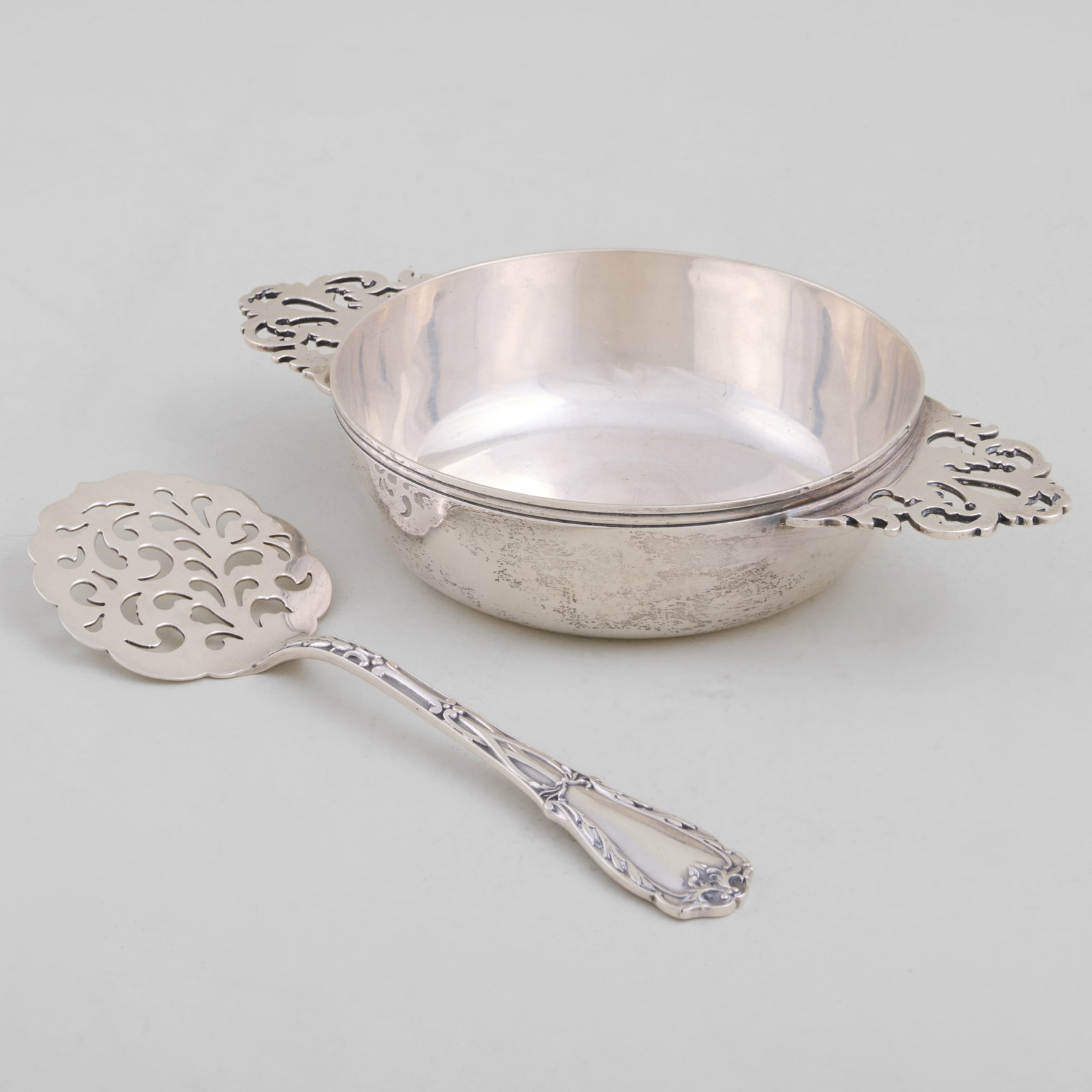 Peter Guille Silver Equelle and a Kirk & Son Bon Bon Spoon: Peter Guille Silver Equelle and a Kirk & Son Bon Bon Spoon Marked 'Sterling'.The equelle 1 5/8 x 8 x 5 in., the spoon 7 1/2 in. long, 10.6 oz. approx. weight. Collection of the Nicholas Brown Family