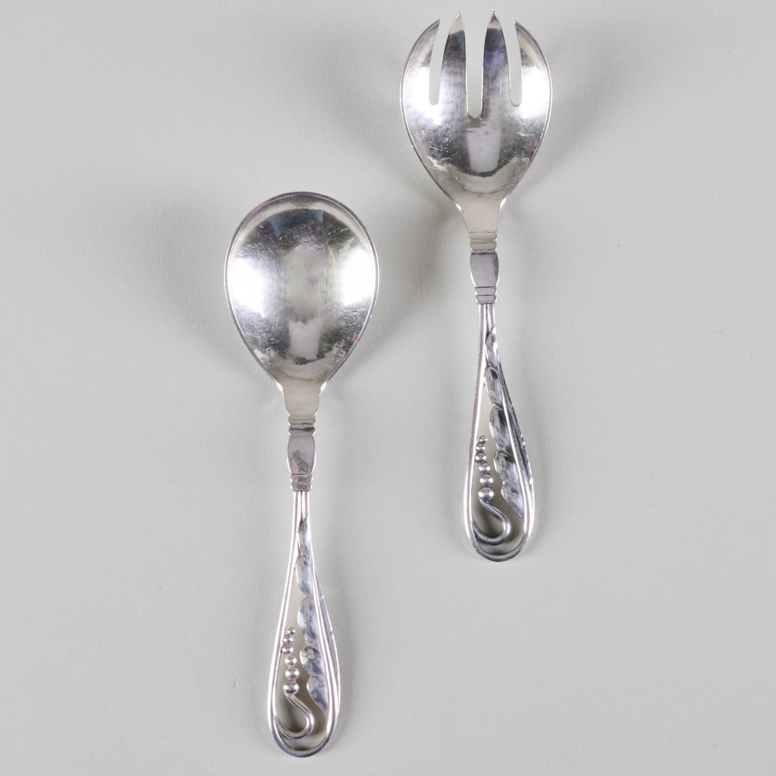 Pair of Small Georg Jensen Silver Servers in the 'Ornamental 42' Pattern: Pair of Small Georg Jensen Silver Servers in the 'Ornamental 42' Pattern Marked 'Sterling'. 6 in. long, 2.3 oz. approx. weight.