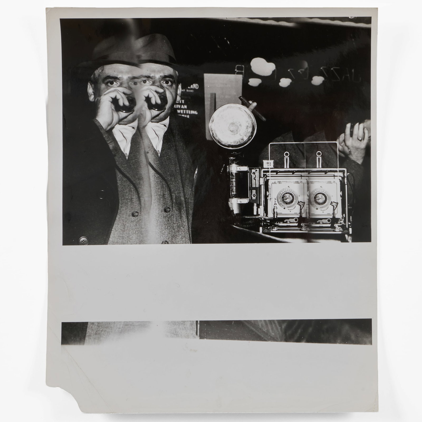 Weegee (1899-1968): Self-Portrait with Drink in Hand and Camera: Weegee (1899-1968): Self-Portrait with Drink in Hand and Camera Gelatin silver print, c. 1950, with the artist's copyright inkstamp on the reverse. 10 x 8 in. (sheet), unframed.