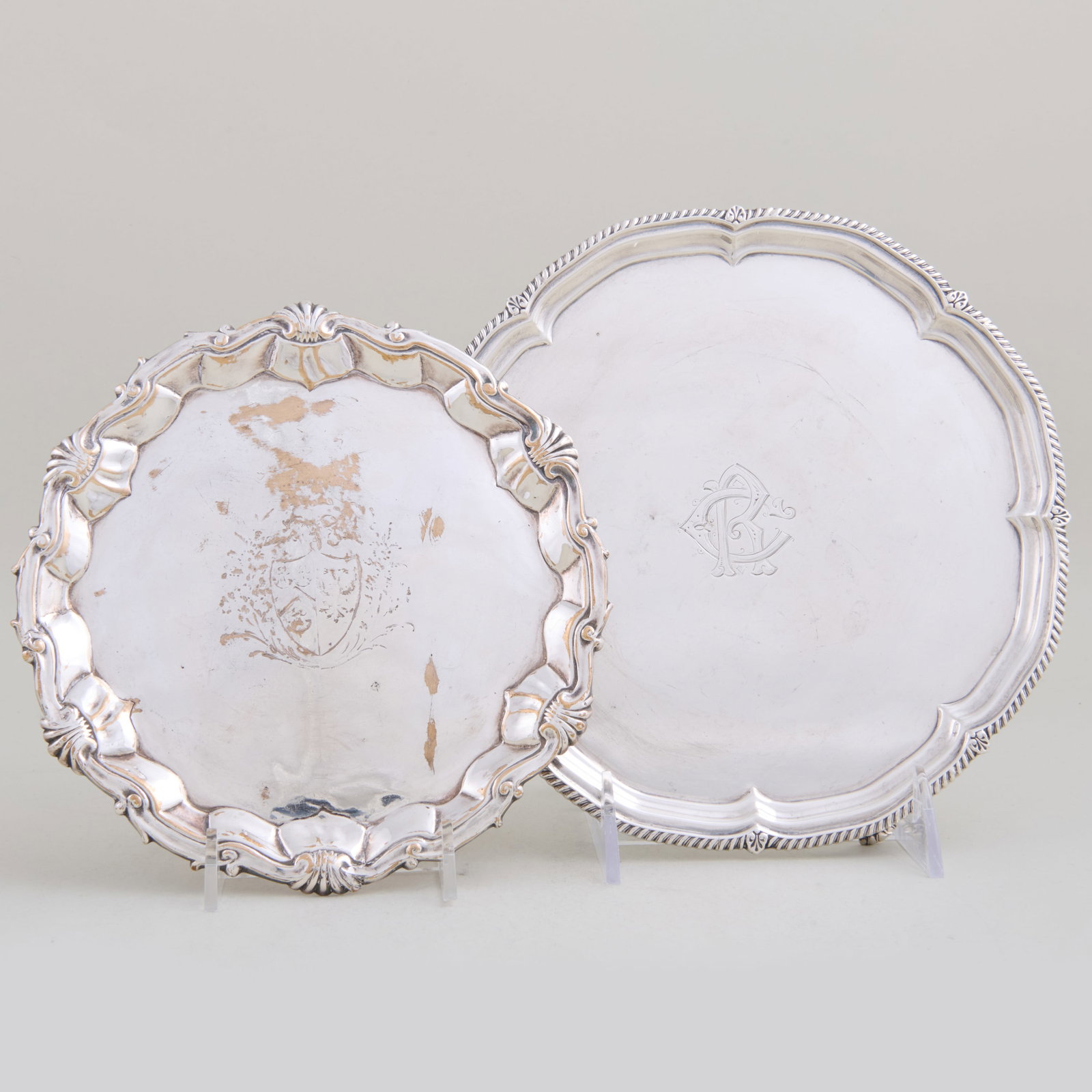 George V Silver Waiter and a Silver Plate Waiter: The silver waiter mark of Harrison Brothers & Howson, Sheffield, 1917, monogrammed; the silver plate engraved with armorial.The silver 3/4 x 8 in. diam., the plate 1 x 7 in. diam., 11.6 oz. approx.