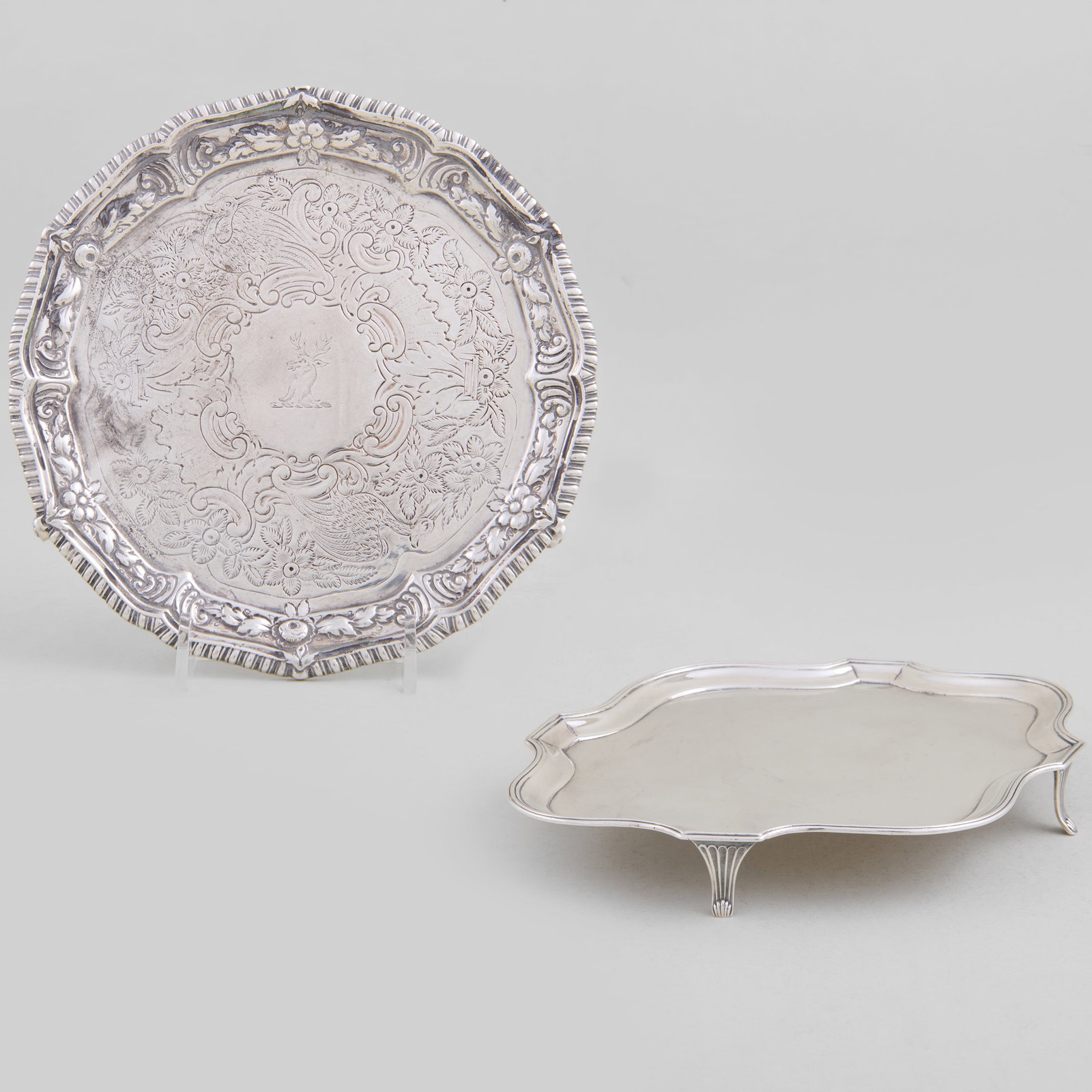 George III Silver Teapot Stand and a Waiter: The stand Peter & Ann Bateman, London, 1790, monogrammed; the waiter marked London, late 19th-early 20th century, later chased and engraved with crest.The stand 1/2 x 7 1/4 x 5 3/4 in., the waiter 1