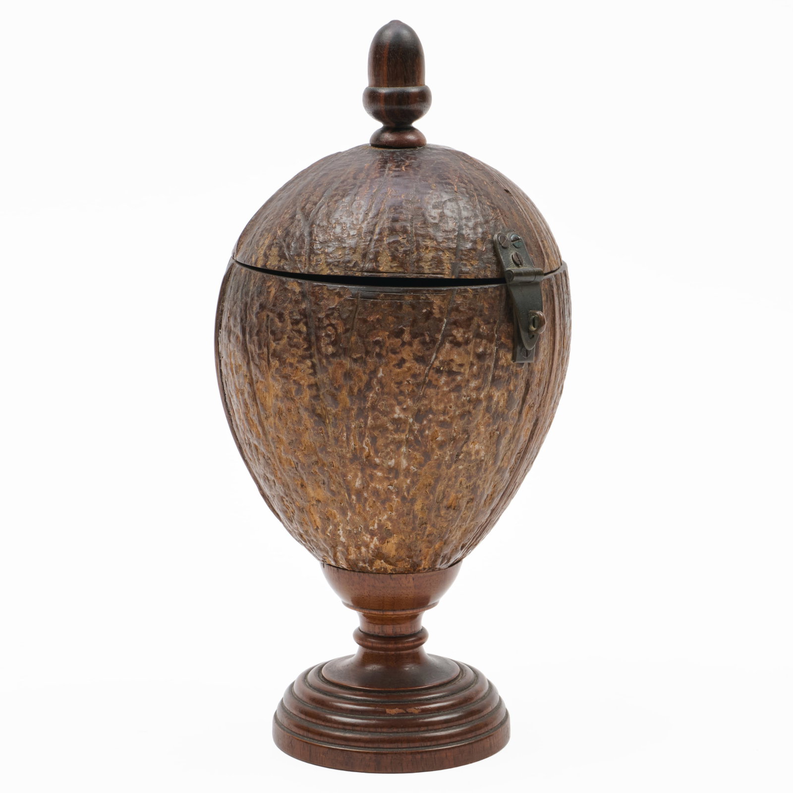 Metal-Mounted Carved Coconut on a Turned Stand: Fitted with an acorn finial.10 x 4 3/4 in. diam.