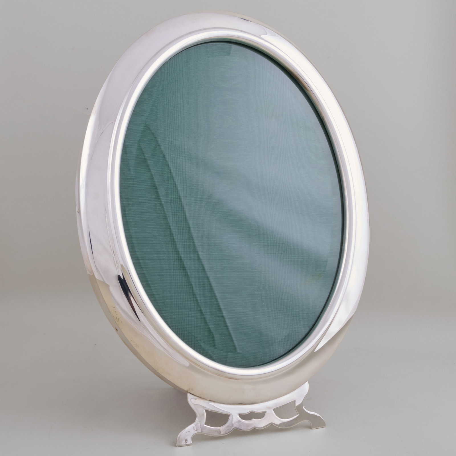 Victorian Silver Oval Frame: Victorian Silver Oval Frame Mark of Walter & John Barnard, London, 1888.17 x 12 in. Property from the Jordan Saunders Collection