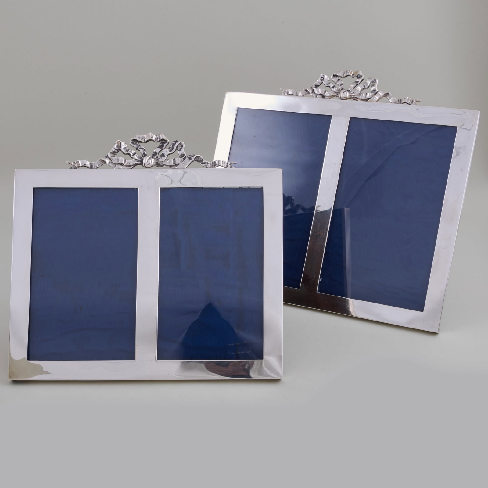 Two George V Double Silver Frames: Two George V Double Silver Frames The smaller Chester, 1912, maker's mark indistinct; the larger mark of E. Mander & Son, Birmingham, 1921.The smaller 8 1/2 x 9 in., the larger 9 3/4 x 10 3/8 in.