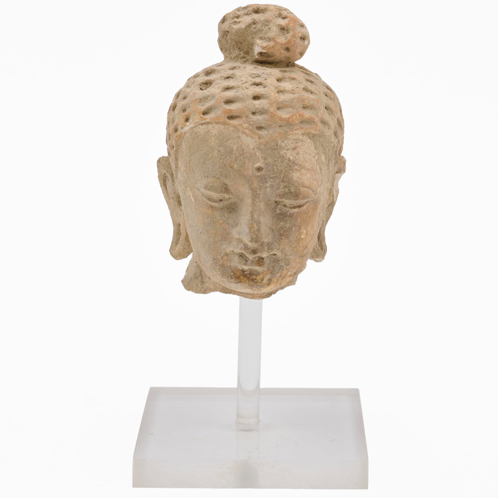 Stone Head of Buddha: Stone Head of Buddha Raised on lucite stand.The head 3 1/2 x 2 1/4 x 3 in., 5 3/4 x 2 3/4 x 2 3/4 in. (overall). The Collection of Roger S. Wieck and Jean-Francois Vilain: Sold to Benefit The Morgan